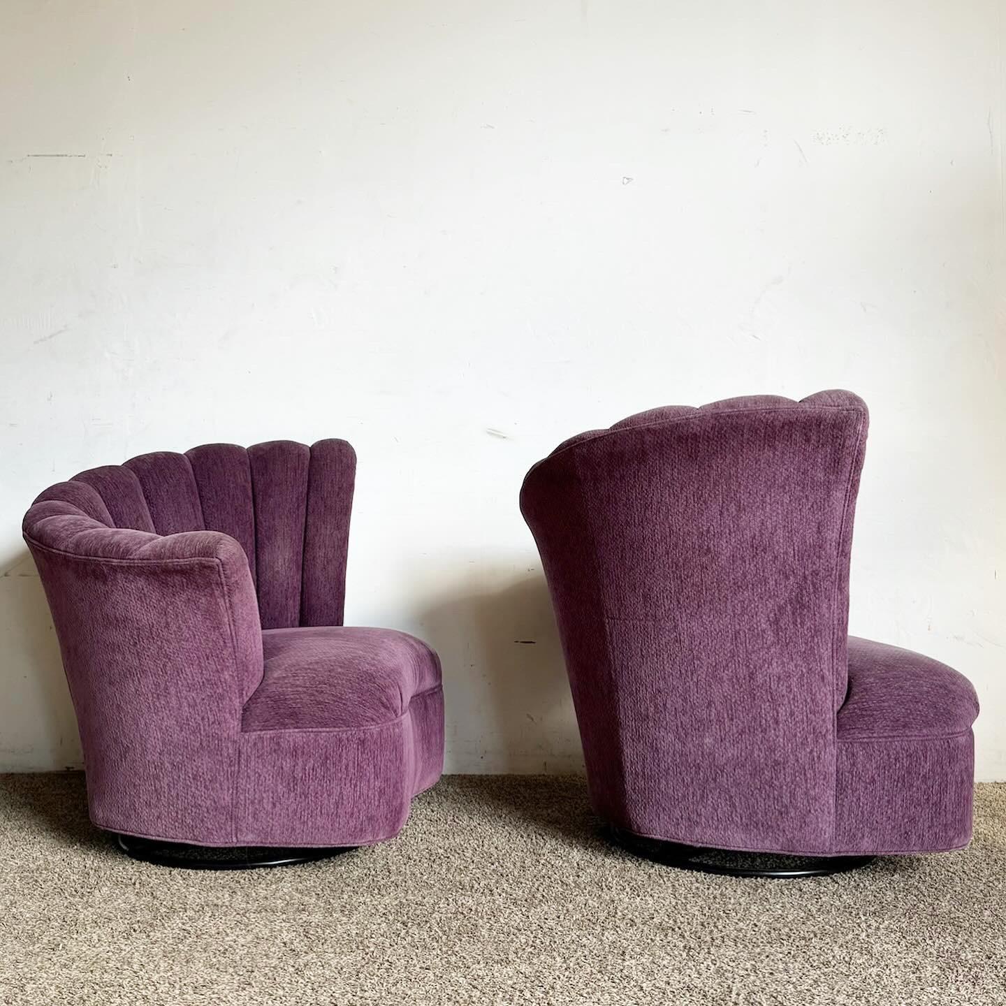 The Postmodern Purple Ascending Clam Shell Back Swivel Chairs, a pair, offer a bold and elegant addition to any space. These chairs showcase a unique clam shell back design, upholstered in vibrant purple fabric, adding dynamic visual appeal. The