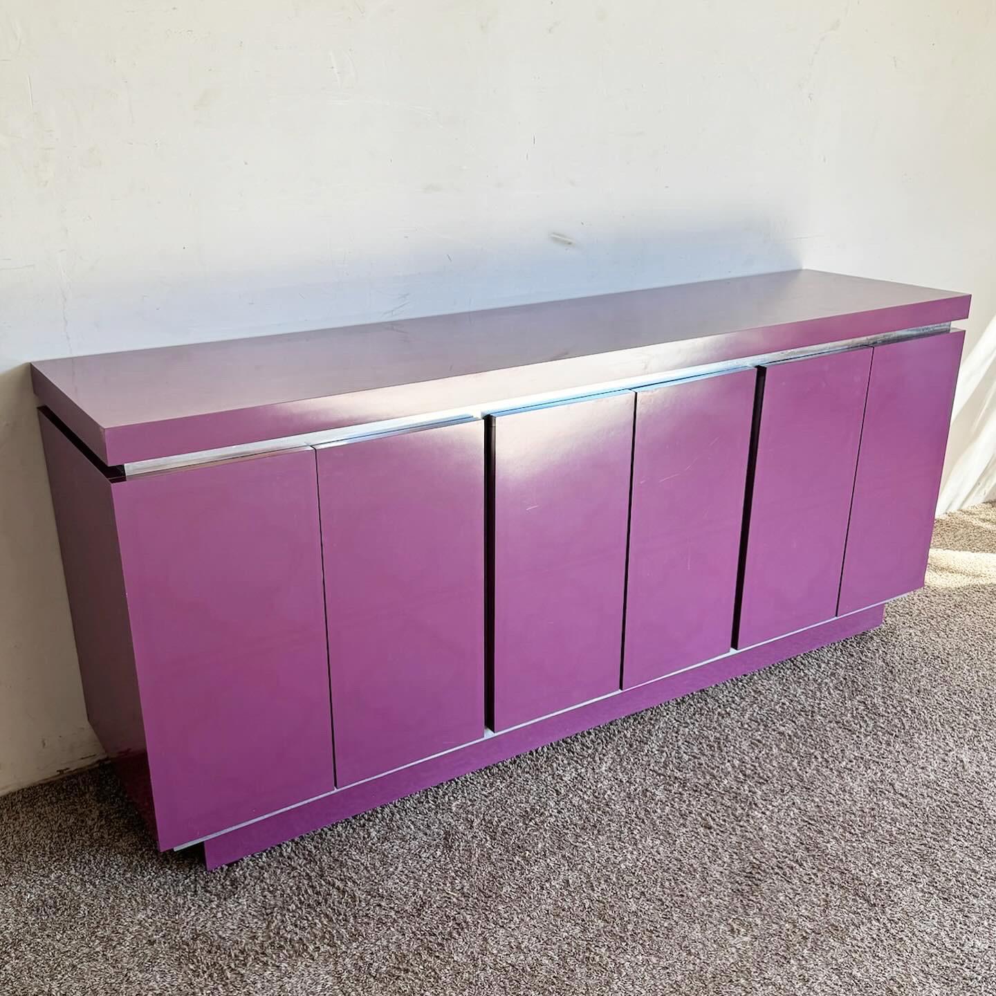 Make a bold statement in your contemporary living space or office with the Postmodern Purple Lacquer Laminate and Brushed Metal Credenza. This eye-catching piece features a vibrant purple lacquer laminate, beautifully complemented by sleek brushed