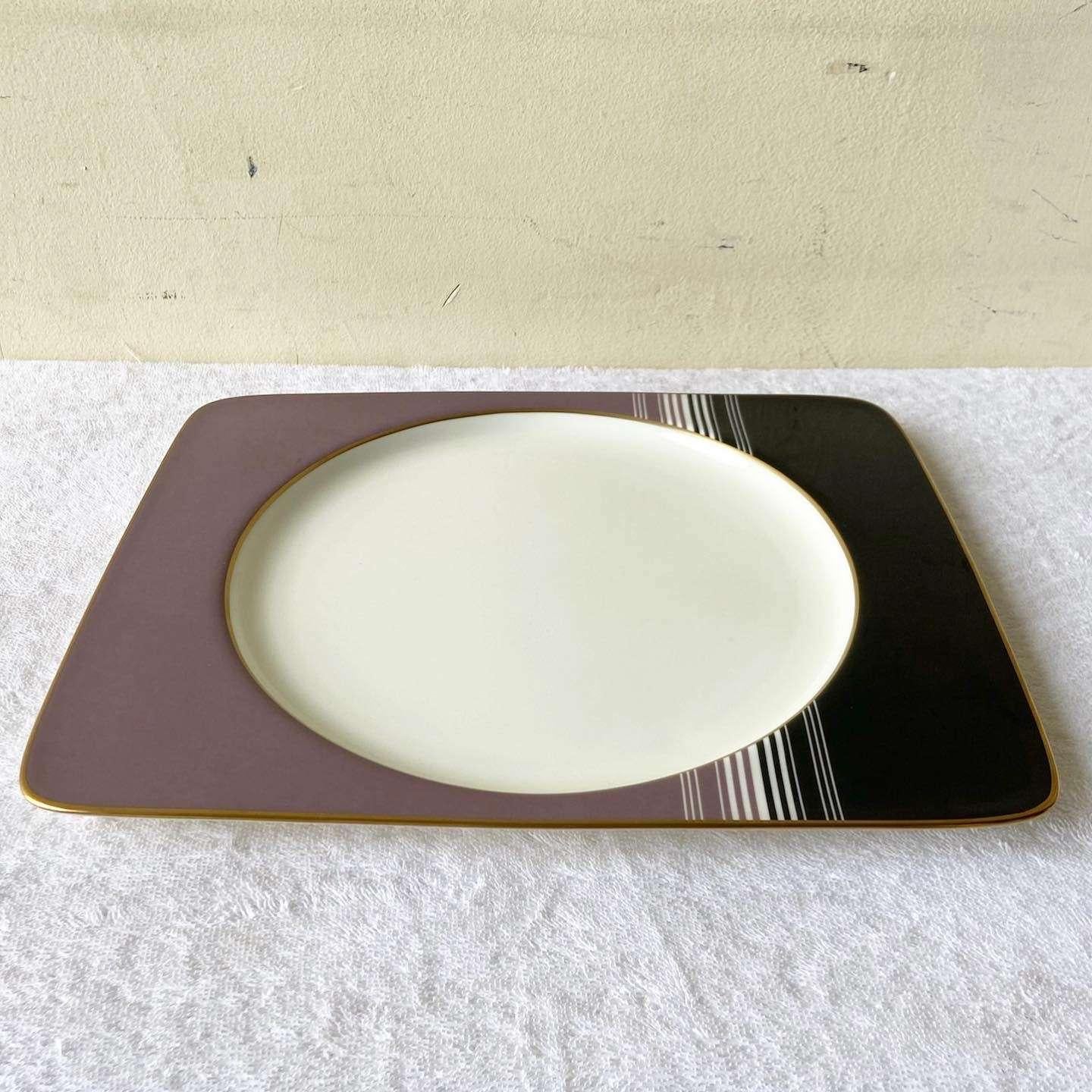 Exceptional vintage postmodern serving platter by Daniel Hechter. Features a purple and back design with a gold border and a white plate interior.