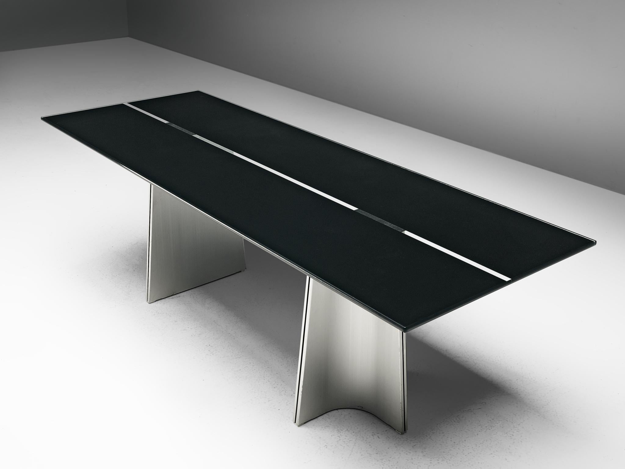 Luigi Saccardo for Arrmet, dining table model 'Ufo', metal and glass, Italy, 1972 

This outstanding dining table is based on a well thought out construction that is aesthetically pleasing. The whole unit is characterized by two sculptural shaped