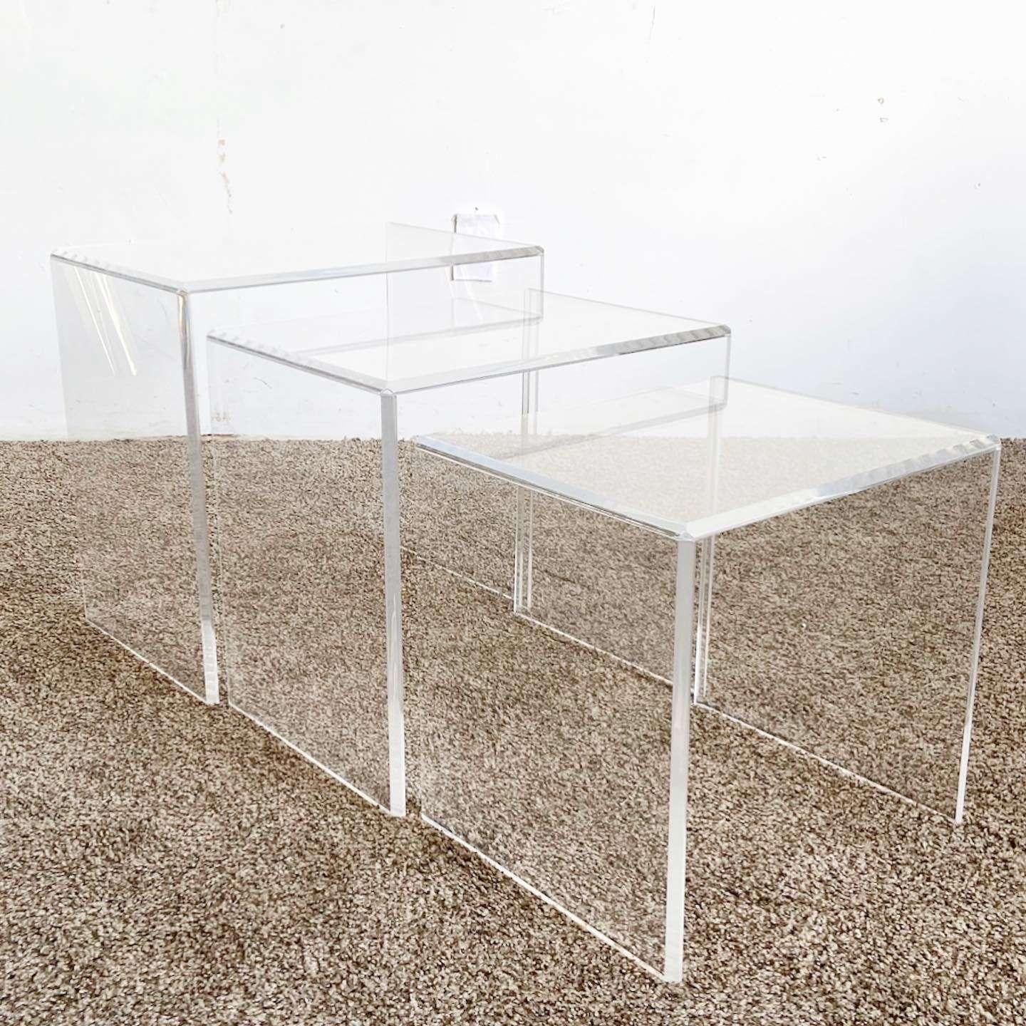Excellent set of 3 vintage postmodern lucite nesting tables. Each table is comprised of three rectangular pieces of lucite.

Small table measures 17”W, 14”D, 16”H
Medium table measures 19”W, 14”D, 18”H