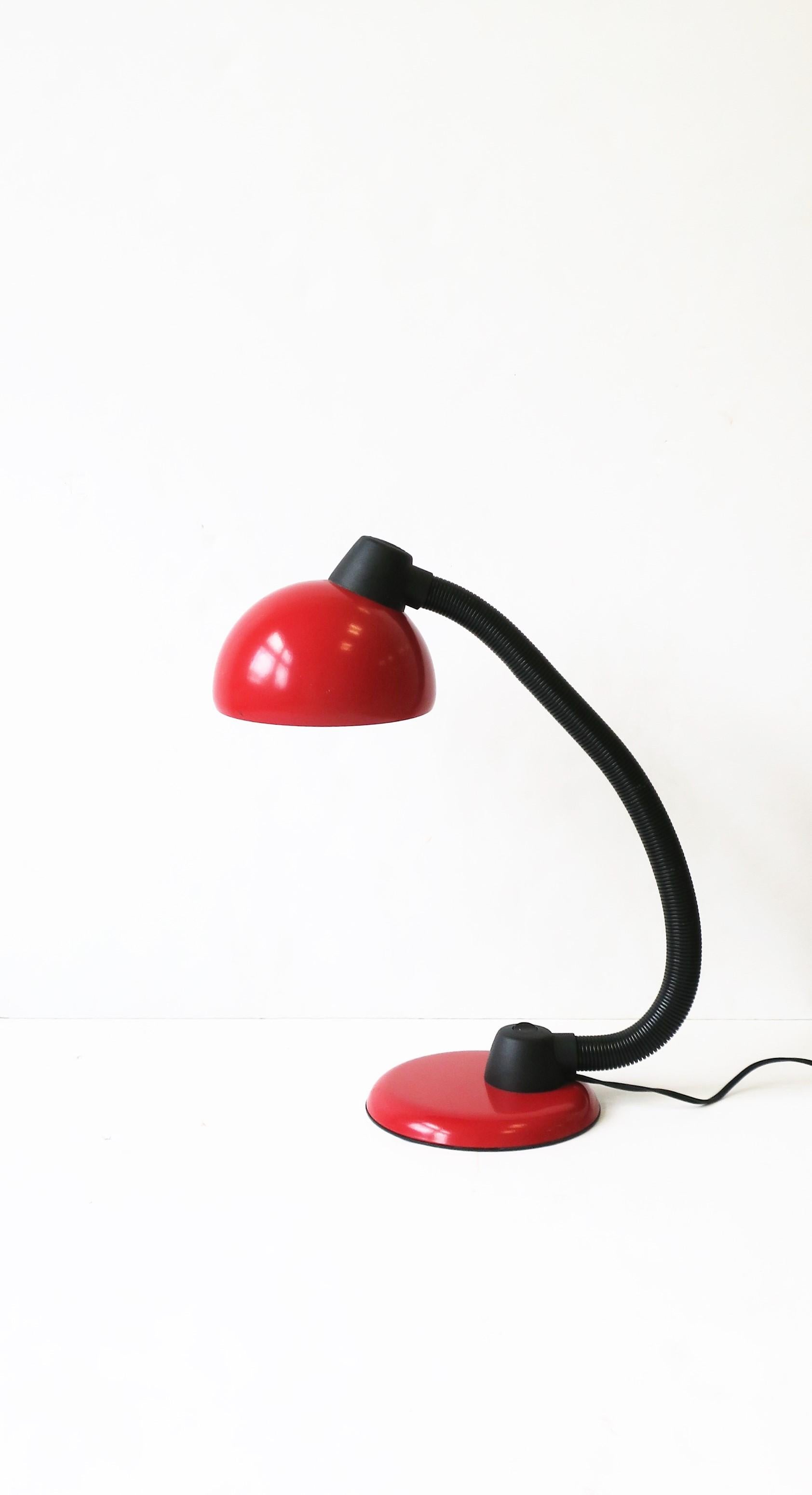 A Postmodern red and black adjustable desk lamp. Shade and base are a red enameled metal. Neck is adjustable. In fine working order for US electric.


  