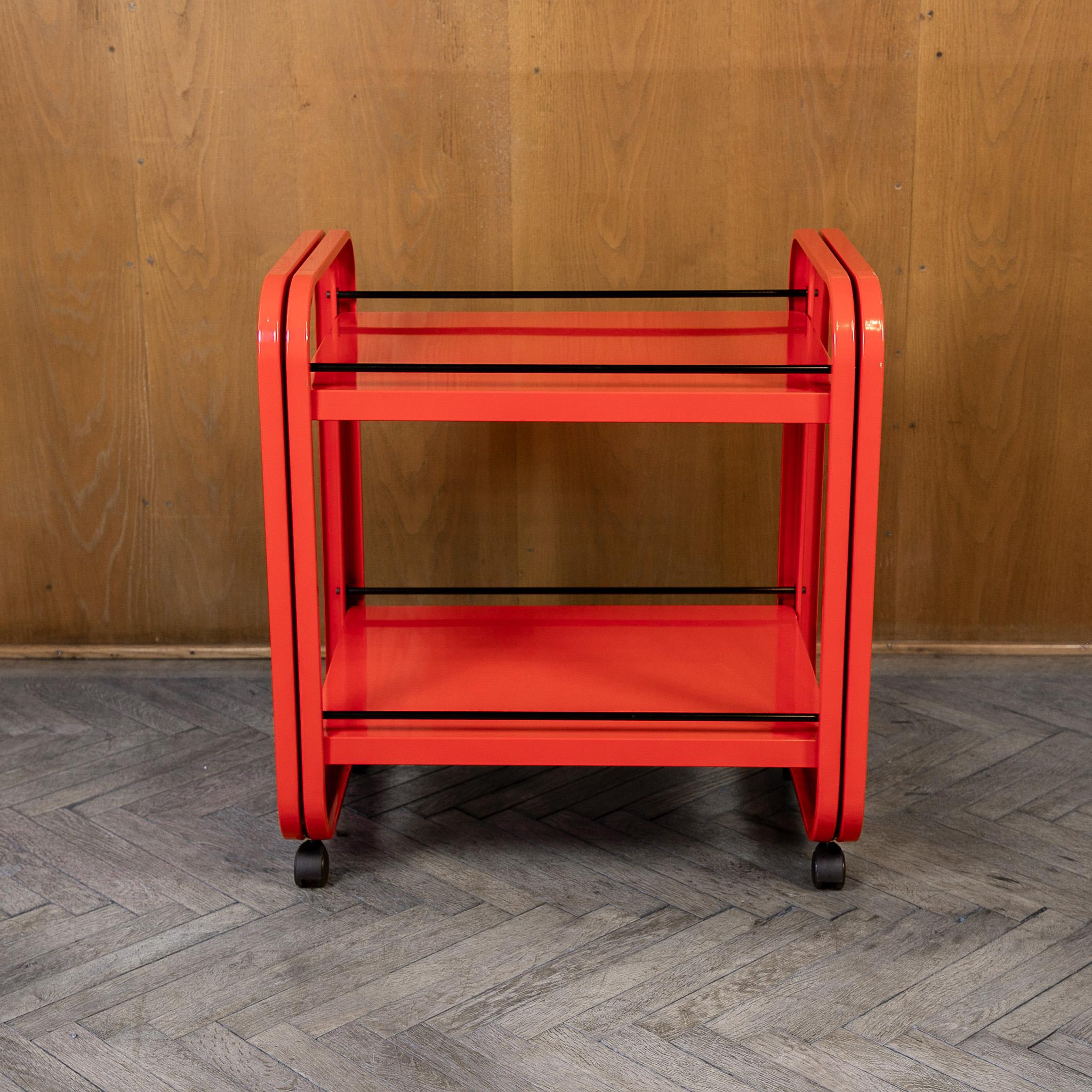 Postmodern Red Metal Trolley for Secco, Italy 1980s.

Thiss vibrant red metal trolley from the 1980s captures the bold, playful spirit of the era. Crafted with precision and flair, the trolley features a bright red powder-coated metal frame that