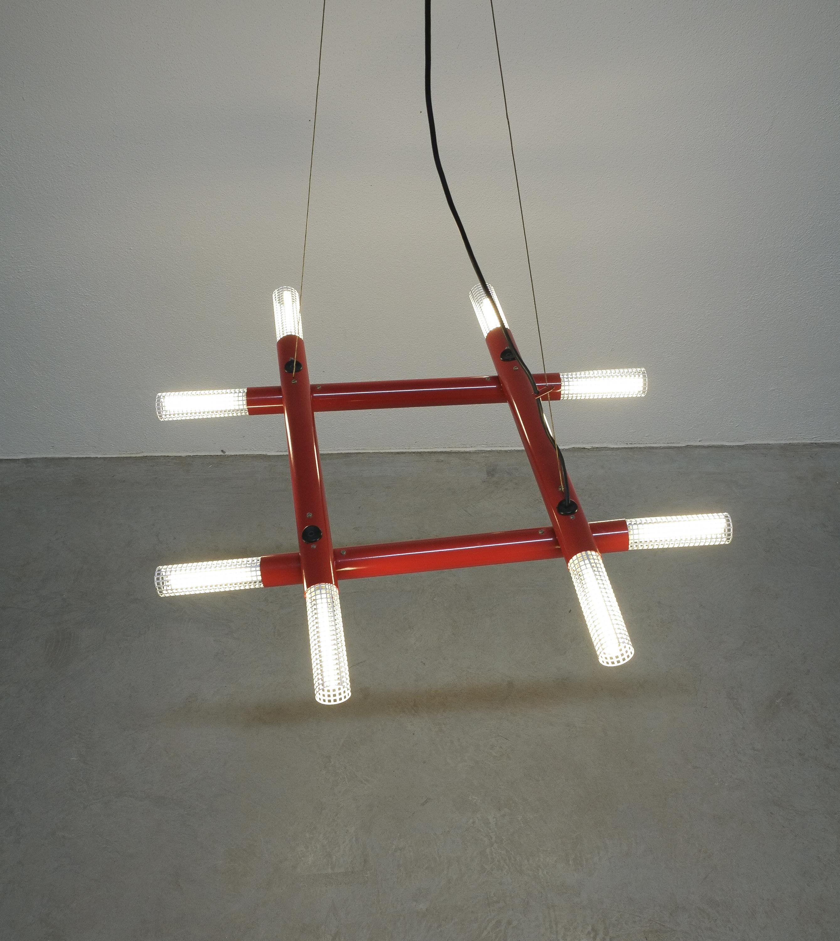 Postmodern red metal atomic chandelier, circa 1980

Cool architectural contemporary chandelier from the 1980s, Italy. It illuminates with 8 bulbs hidden behind white perforated metal diffusers. It can be adjusted pivoting the red tubes. The
