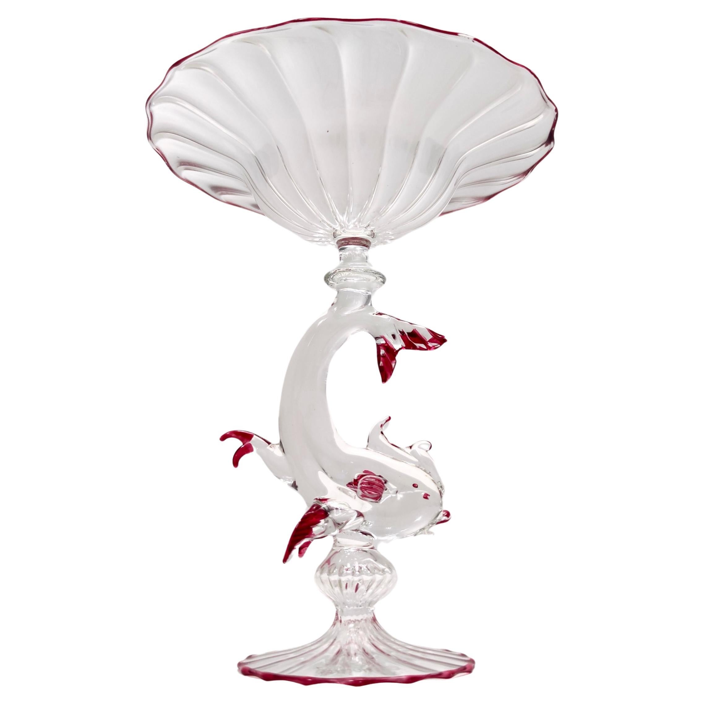 Made in Italy, 1970s - 1980s. 
This cake stand / pedestal bowl is made in Murano glass and features a fish-shaped stem. 
It is signed by La Murrina. 
This is a vintage piece, therefore it might show slight traces of use, but it can be considered as