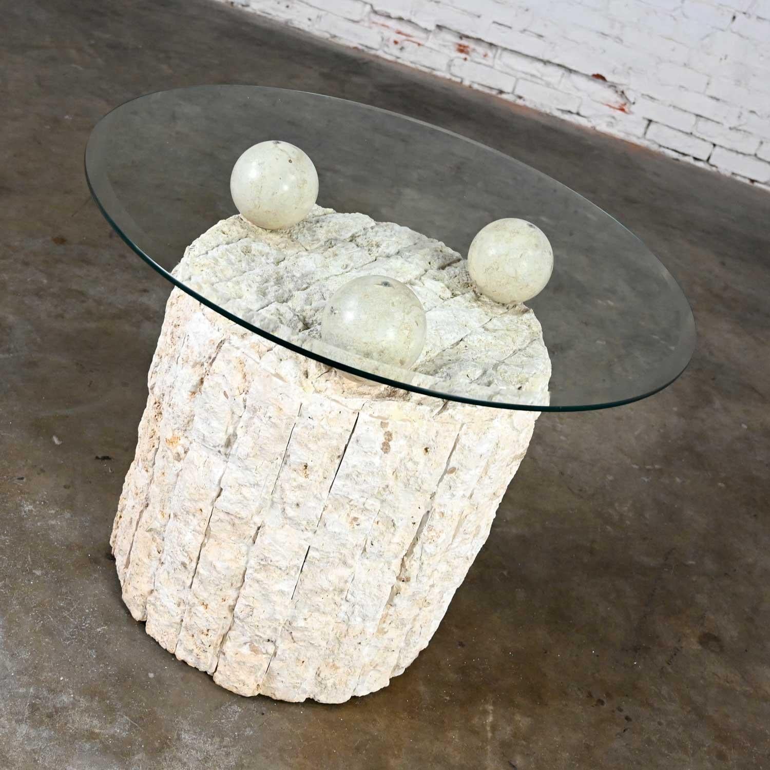 Fabulous postmodern tessellated Mactan rough edge stone round pedestal base side table with 3 polished spheres and a round beveled glass top in the style of Maitland Smith. Beautiful condition, keeping in mind that this is vintage and not new so