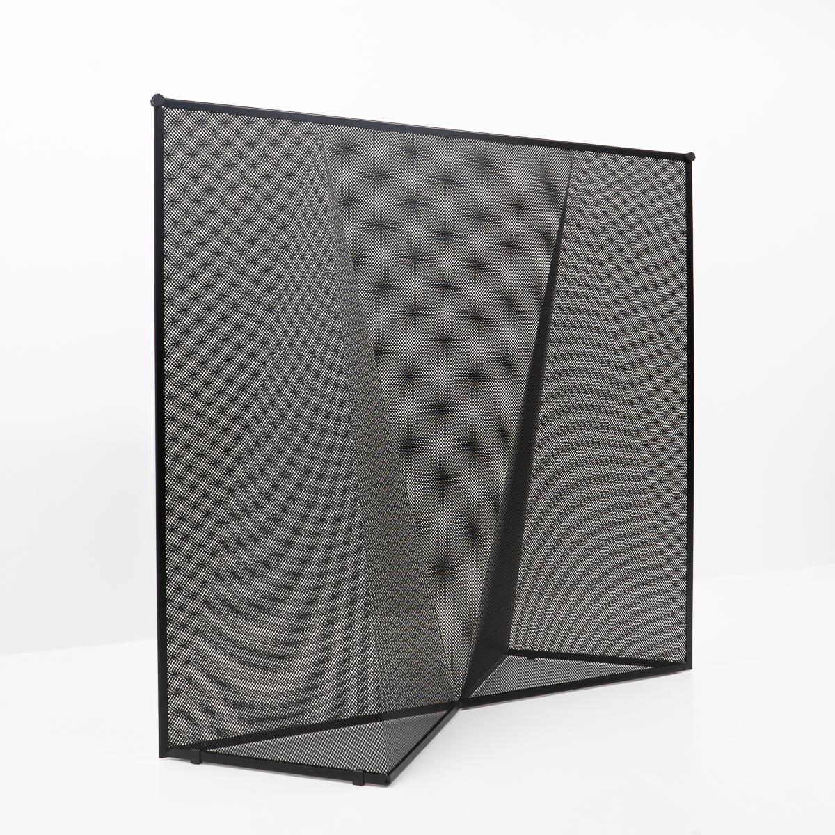 Nilla Rosa room divider by Mario Botta for Alias, Italy. No longer in production. 

The room divider or paravent consists of two sheets of perforated metal bent into geometrical shapes. The structure gives a very interesting effect, as the play of
