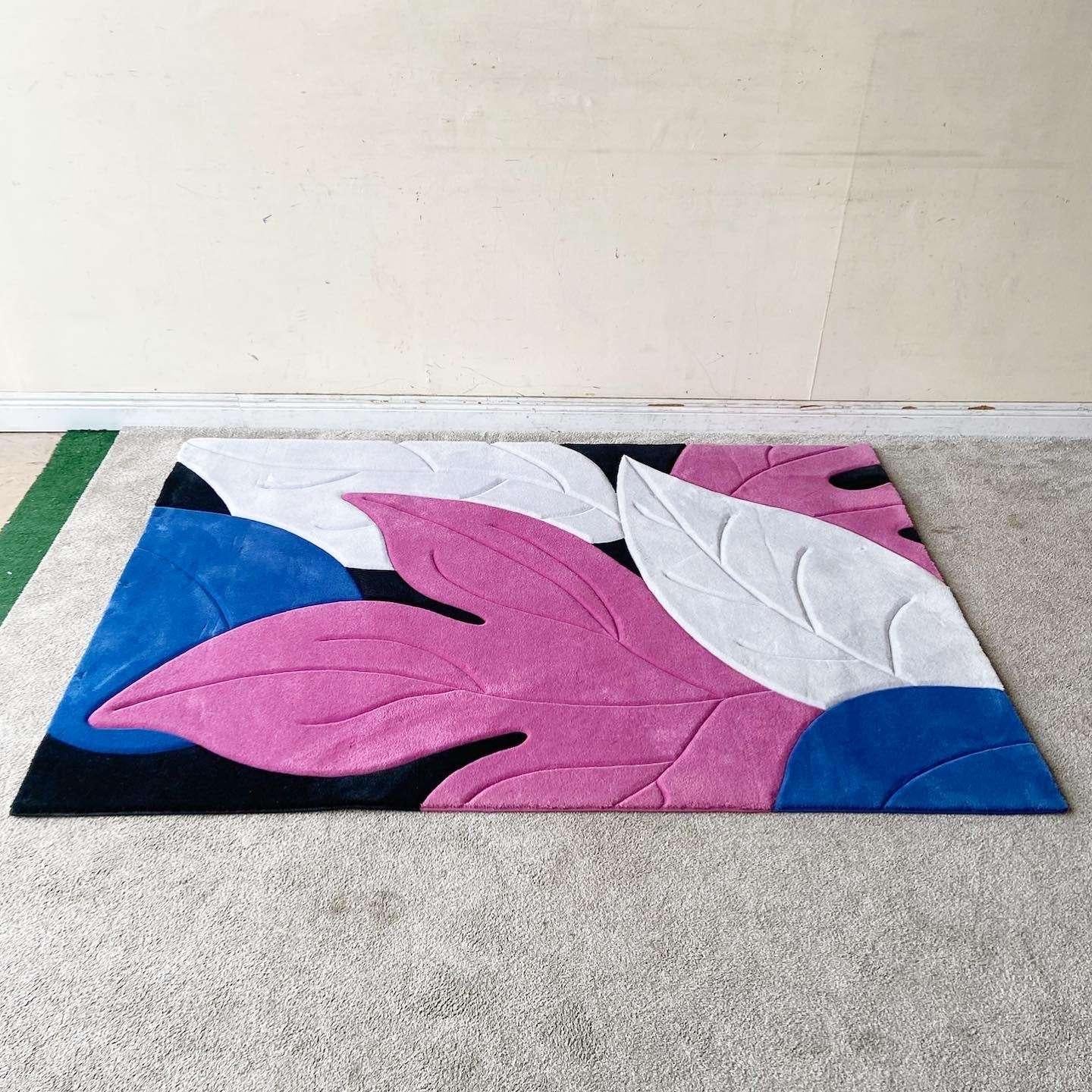 Exceptional vintage postmodern rectangular area rug. Features a vibrant display of pink, white and blue foliage on a black backdrop.

Rug 6
