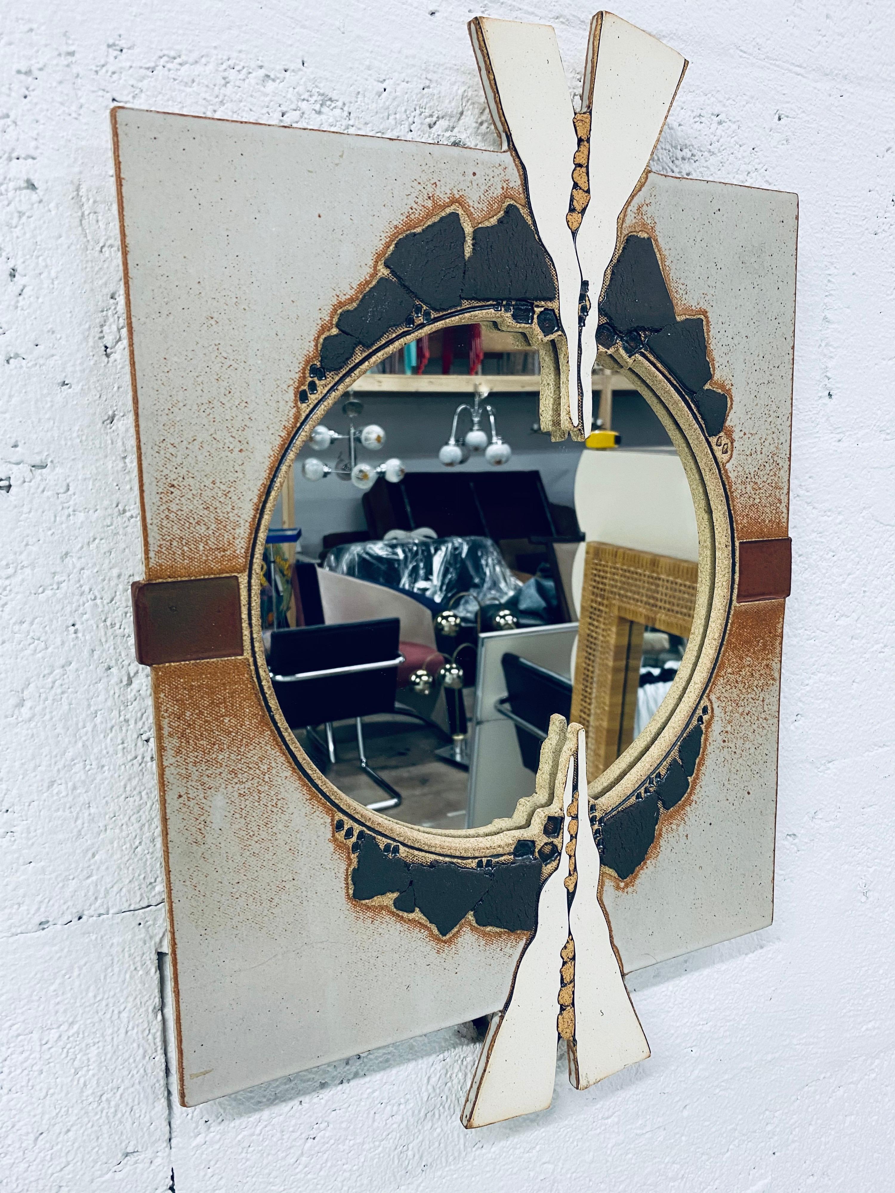 Artist-signed Postmodern sculpted ceramic mirror from 1983.