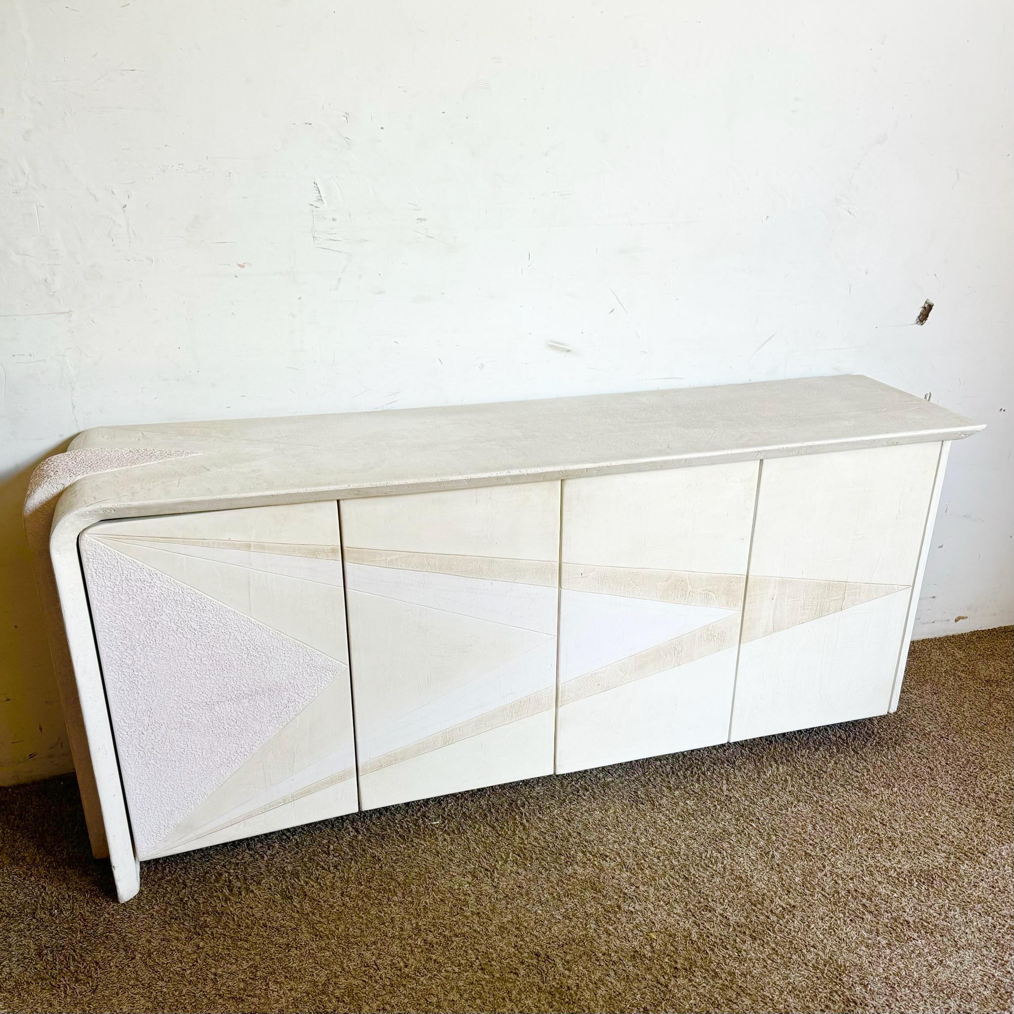 Make a bold statement with this postmodern sculpted plaster credenza in white and pink/mauve. Its artistic sculpted design and soft color palette create a unique blend of modern sophistication and playful elegance. Perfect as a standout storage