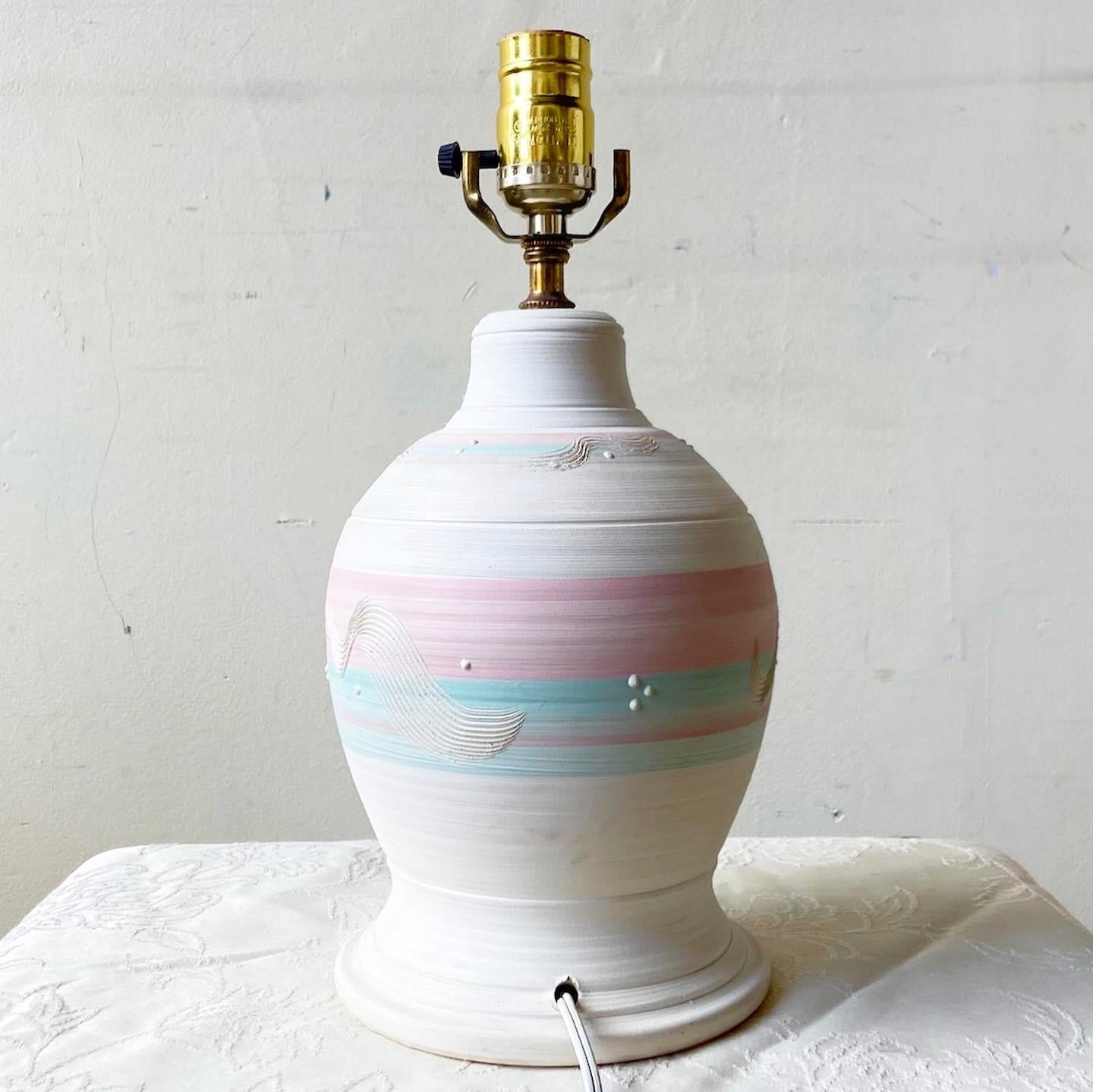 Exceptional postmodern sculpted pottery table lamp. Feasted a fantastic pink and green finish.

Additional information:
Material: Pottery
Color: Pink
Style: Postmodern
Time Period: 1980s
Place of origin: USA
Dimension: 6
