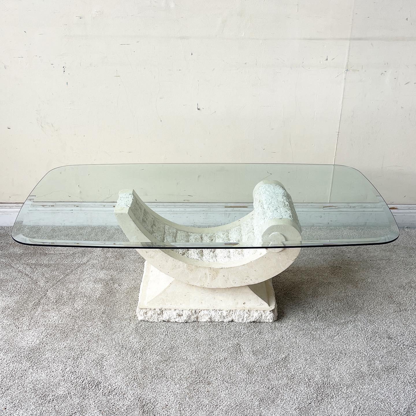 Exceptional vintage postmodern tessellated stone glass top coffee table. Features a sculpted ribbon base with a beveled glass top.