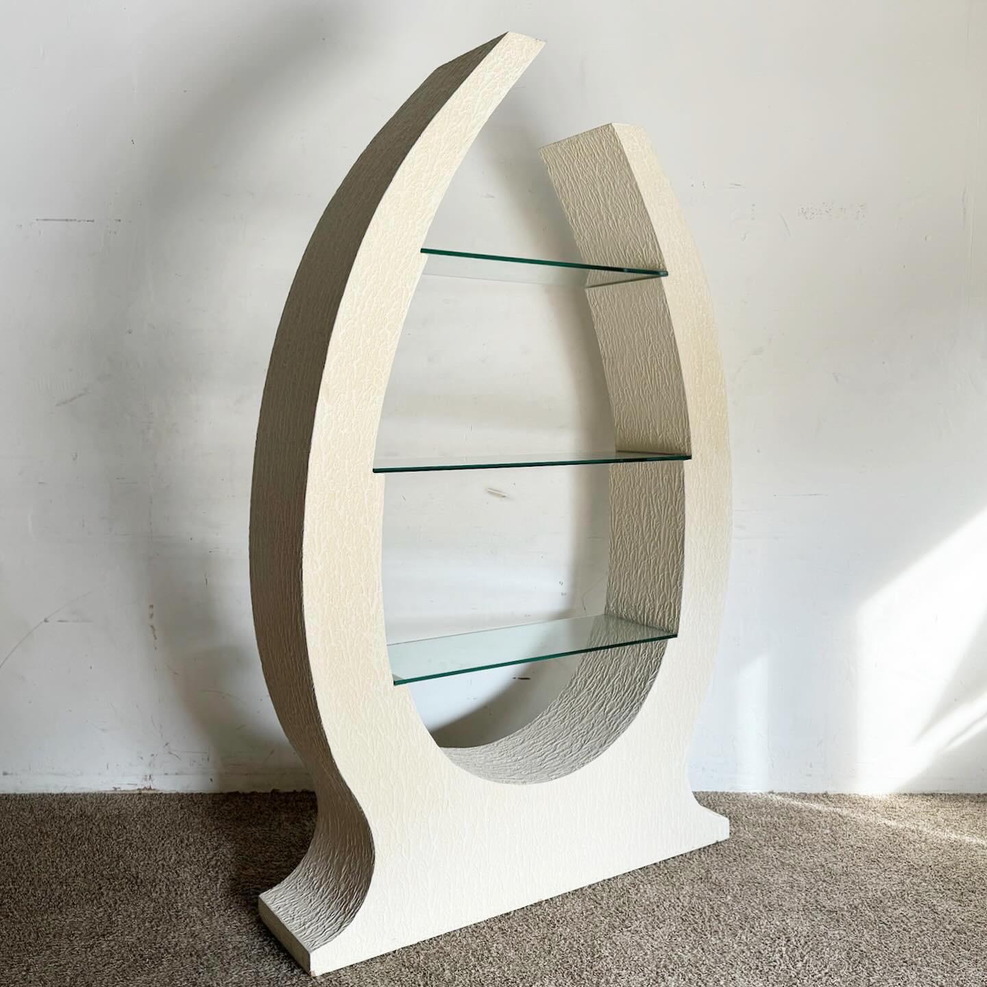 The Postmodern Sculpted White Stucco Etagere/Bookshelf is a unique addition to any space, blending artistic design with functionality. Its sculpted form and white stucco finish add a contemporary and dynamic touch, suitable for various decor styles.