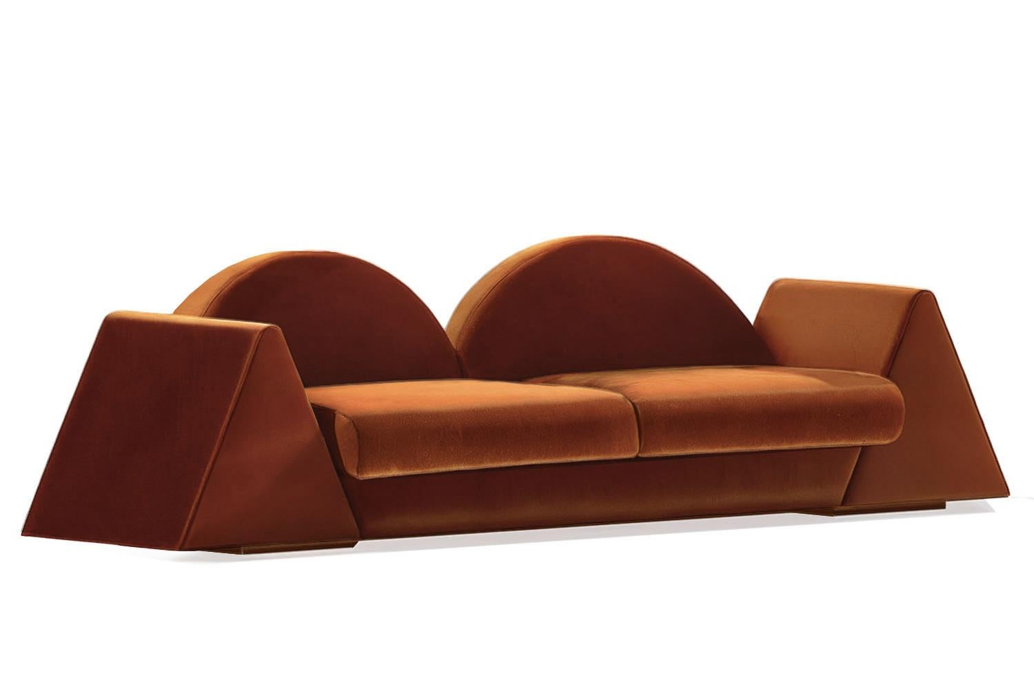The Amanecer Sofa is a sculptural tribute to new beginnings—an ode to the calm strength of dawn. With its bold geometric silhouette, twin-arched backrest, and solid triangular arms, this piece evokes the horizon where light first breaks. Upholstered