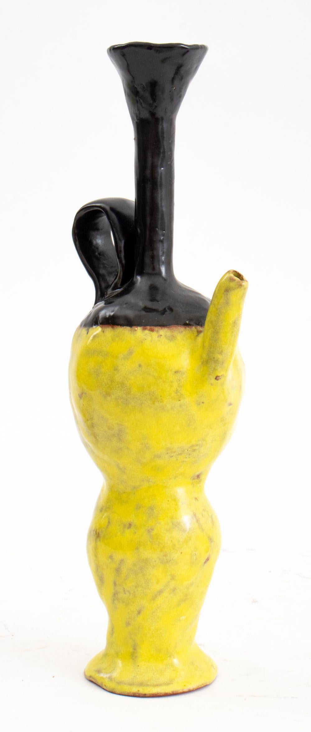Set of Five Articles of Postmodern Sculptural Pottery Tableware, three salt and pepper shakers, one red boat-form pitcher, and one black and yellow oil and vinegar jar, signed 