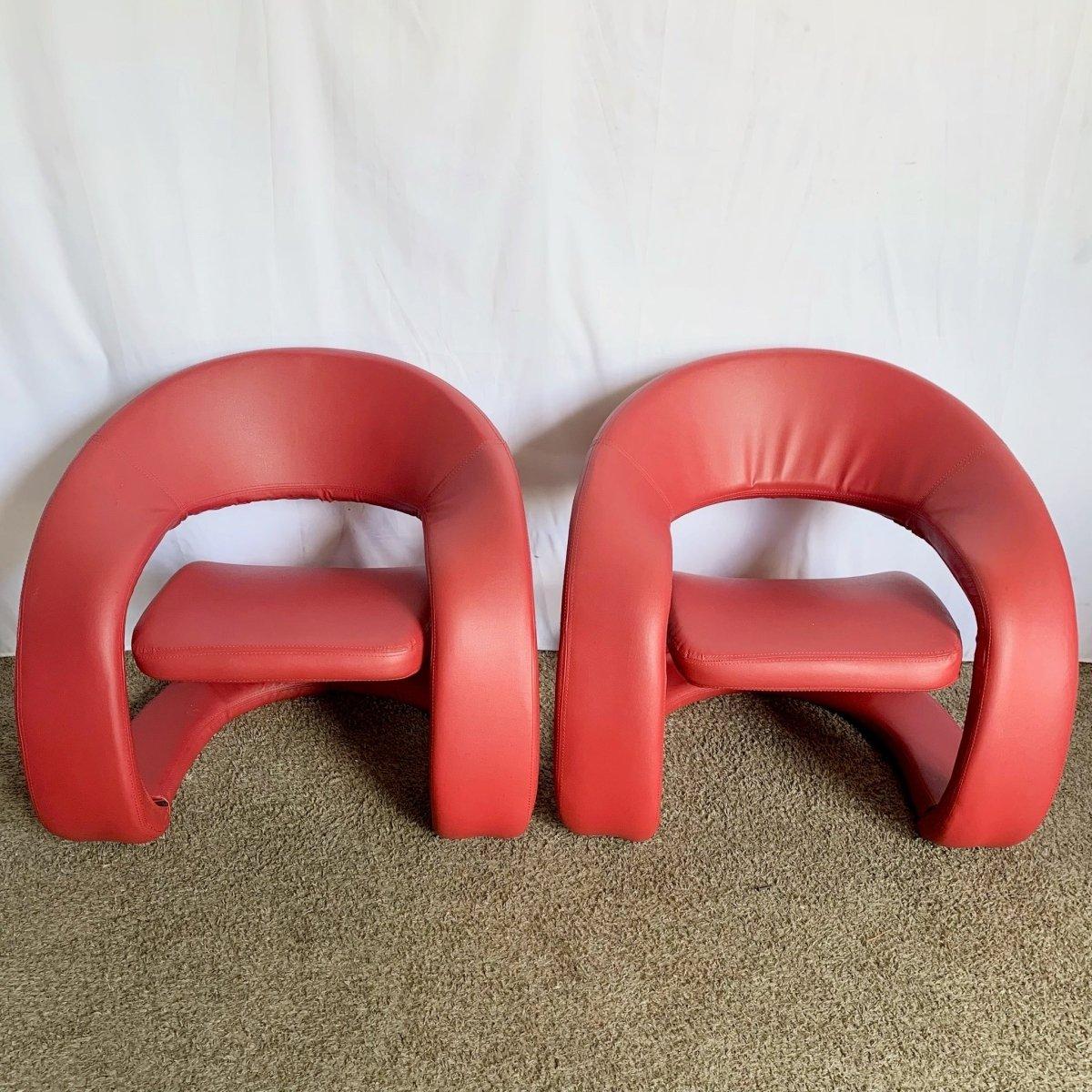 Postmodern Sculptural Red Lounge Chairs blend bold sculptural curves and plush red elegance, ideal for upscale, statement interiors.
 

 One of the spring underneath has pocked through as can be seen in the photos.
 

 We sell items as acquired,