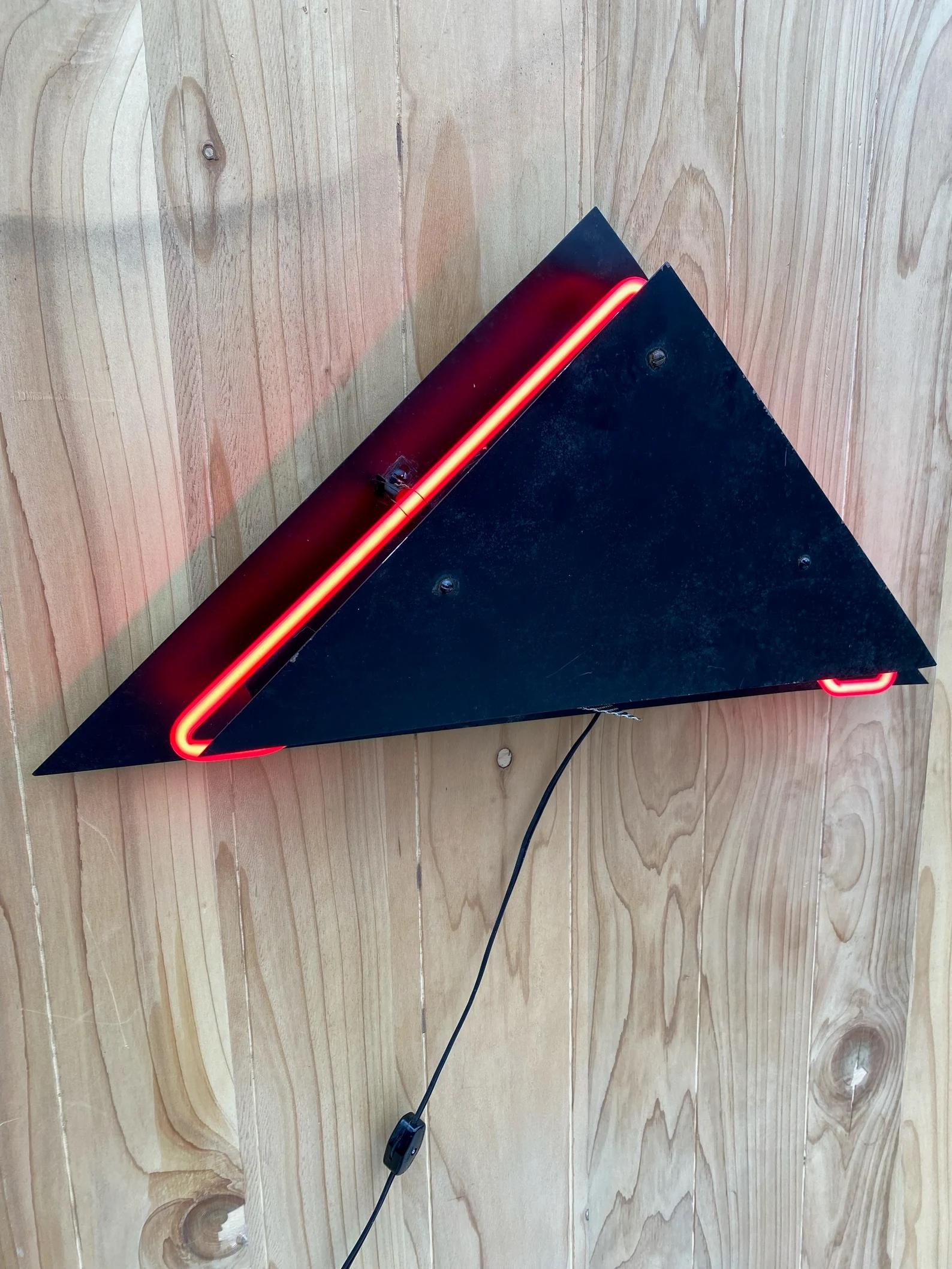 Postmodern Sculpture Torchiere Wall Sconce Rudi Stern “Let There Be Neon” Style - Pair

These postmodern triangle lamps would beautifully decorate your wall with their red glow. The lighting frame is constructed from aluminum. This piece includes a