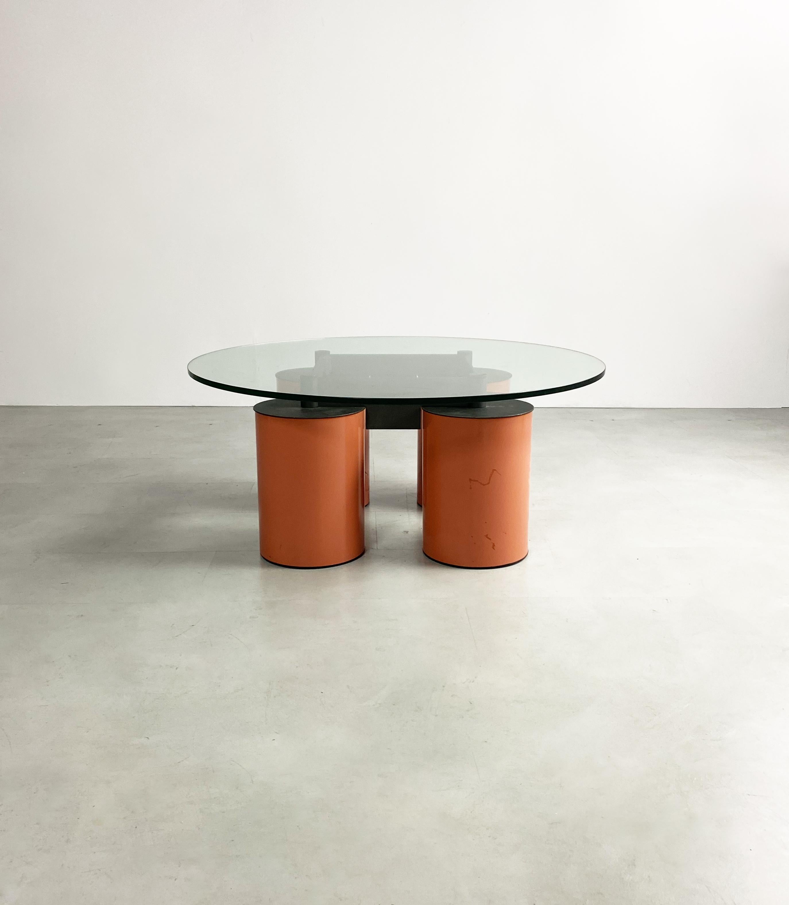 Superb postmodern Italian design from the Vignelli’s with peach lacquered, oversized steel drum legs and granite coloured powder coasted base supporting the circular glass top.

Dimensions (cm, approx): 
Height: 37
Diameter: 111


Condition: