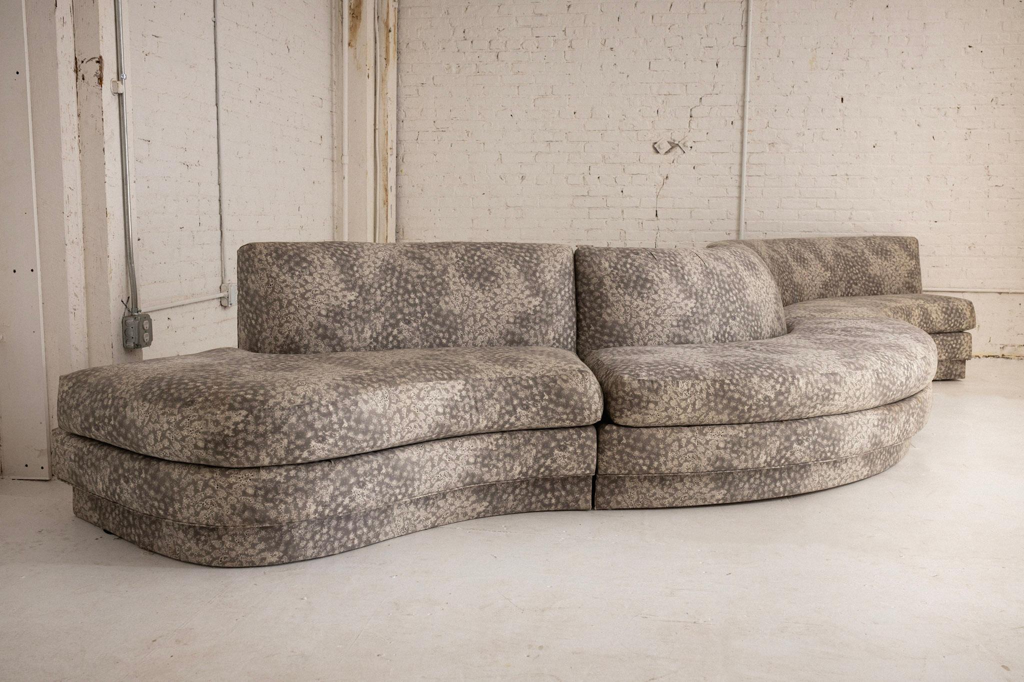 A 3 piece Postmodern serpentine sectional manufactured by Royal Lounge Co. Original graphic print cotton upholstery. Reupholstery recommended. Three pieces can be arranged at your discretion to alter the shape of the sofa. Retains original