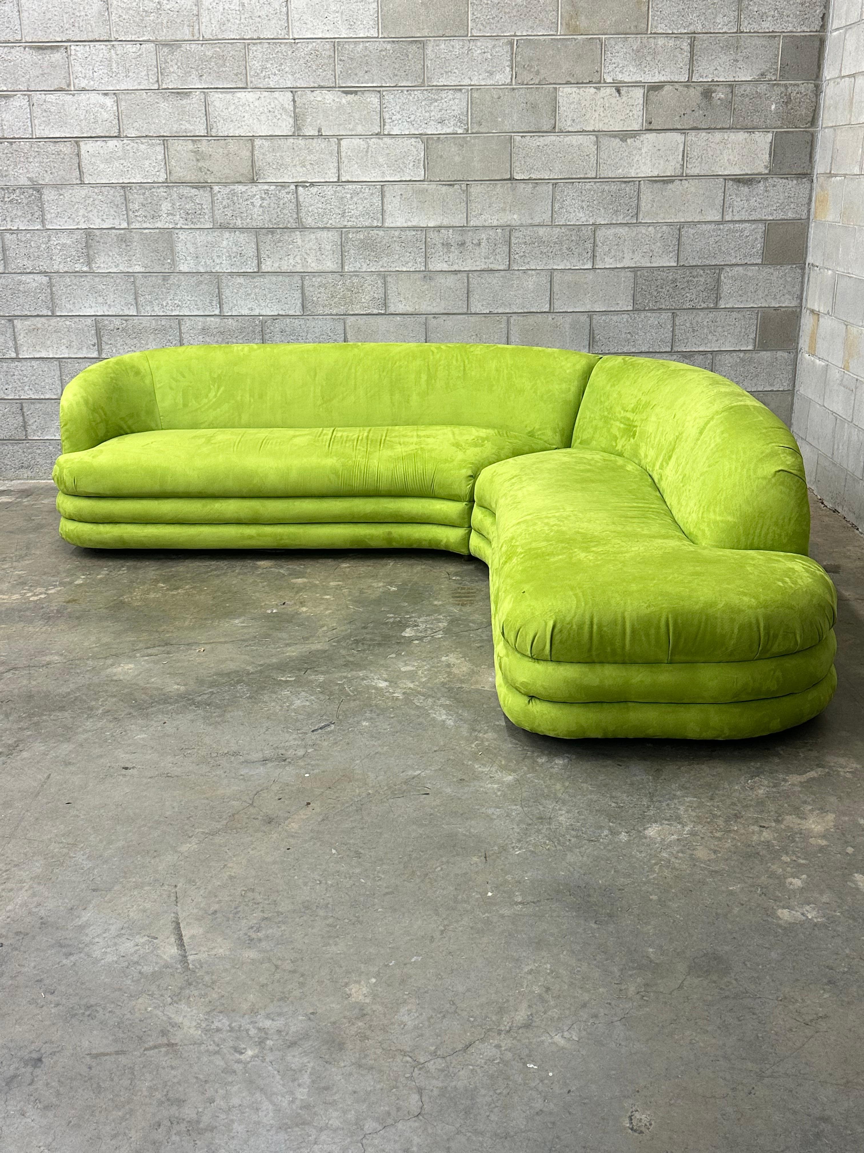 Interesting postmodern style sofa with a serpentine like shape. Great organic L shape sofa with an overall foot print of 106” x 106”. Back height is 29” and seat height is 17.5”. Sofa is composed of two equal sized sections each measuring 90” long,