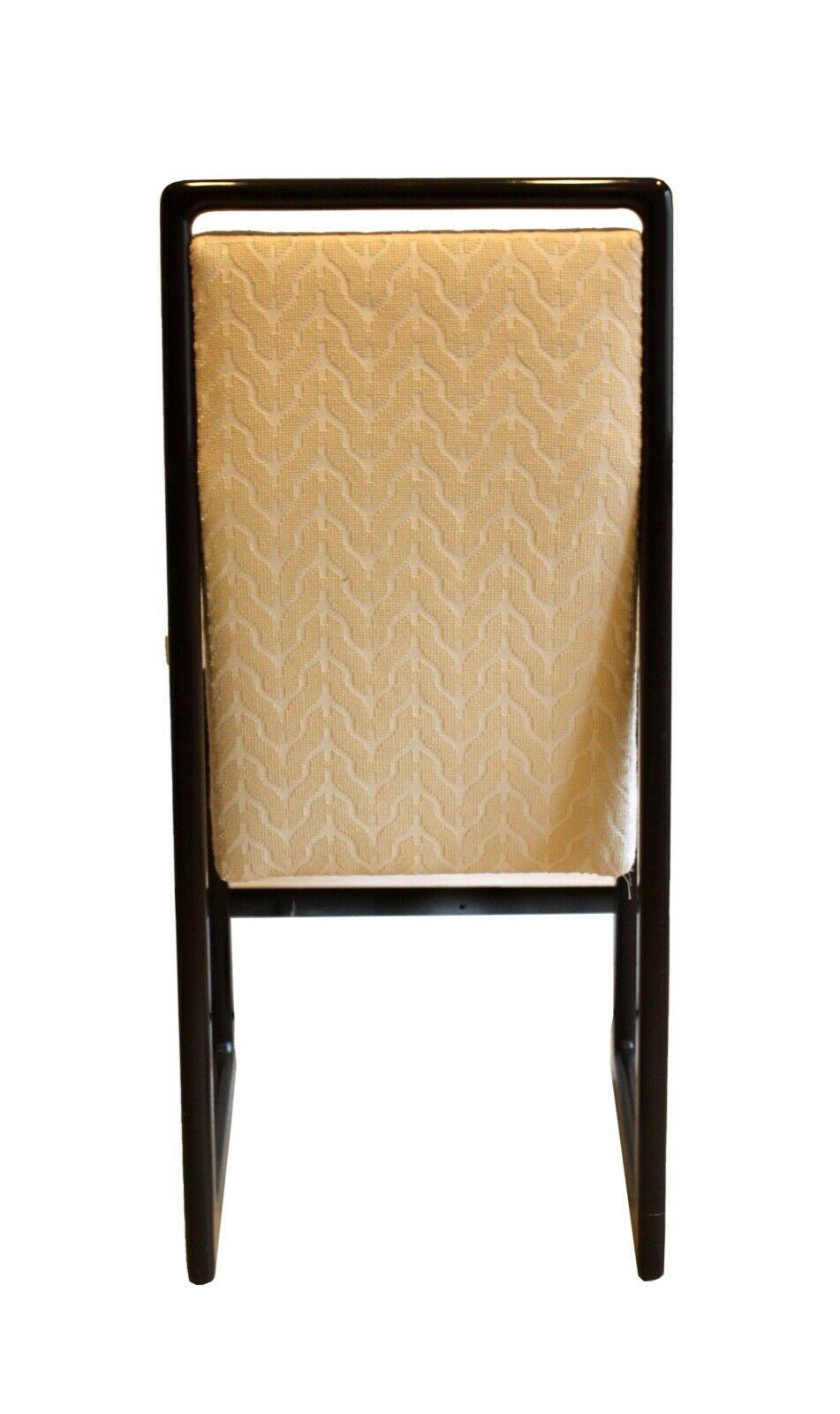 Signed by Vladimir Kagan, this set of postmodern dining chairs are designed in classical, cubist style with dark wood frames surrounding two arm chairs and six side chairs. Neutral upholstery covers both the seat and back making these the perfect