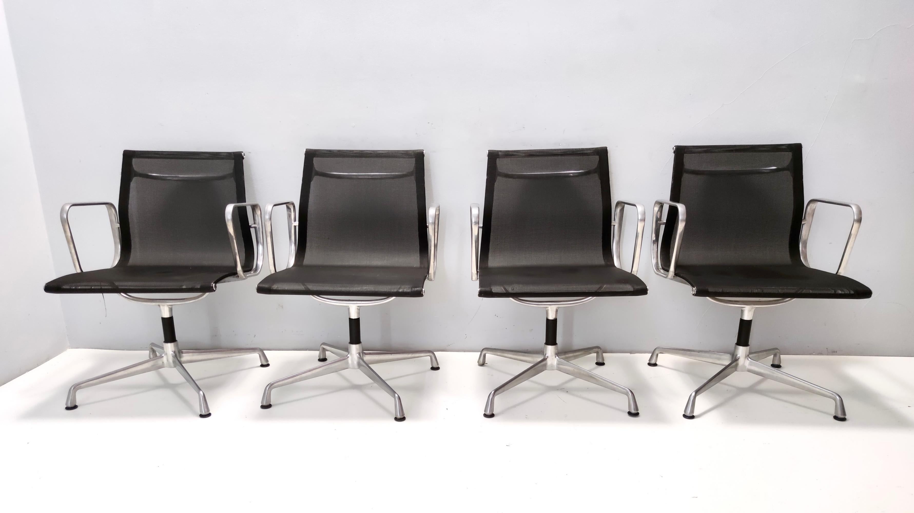 Made in Italy, 1980s. 
These desk chairs feature a black nylon and aluminum frame. 
They are revolving but not reclining, and height is not adjustable. 
This set might show slight traces of use since it's vintage, but it can be considered as in