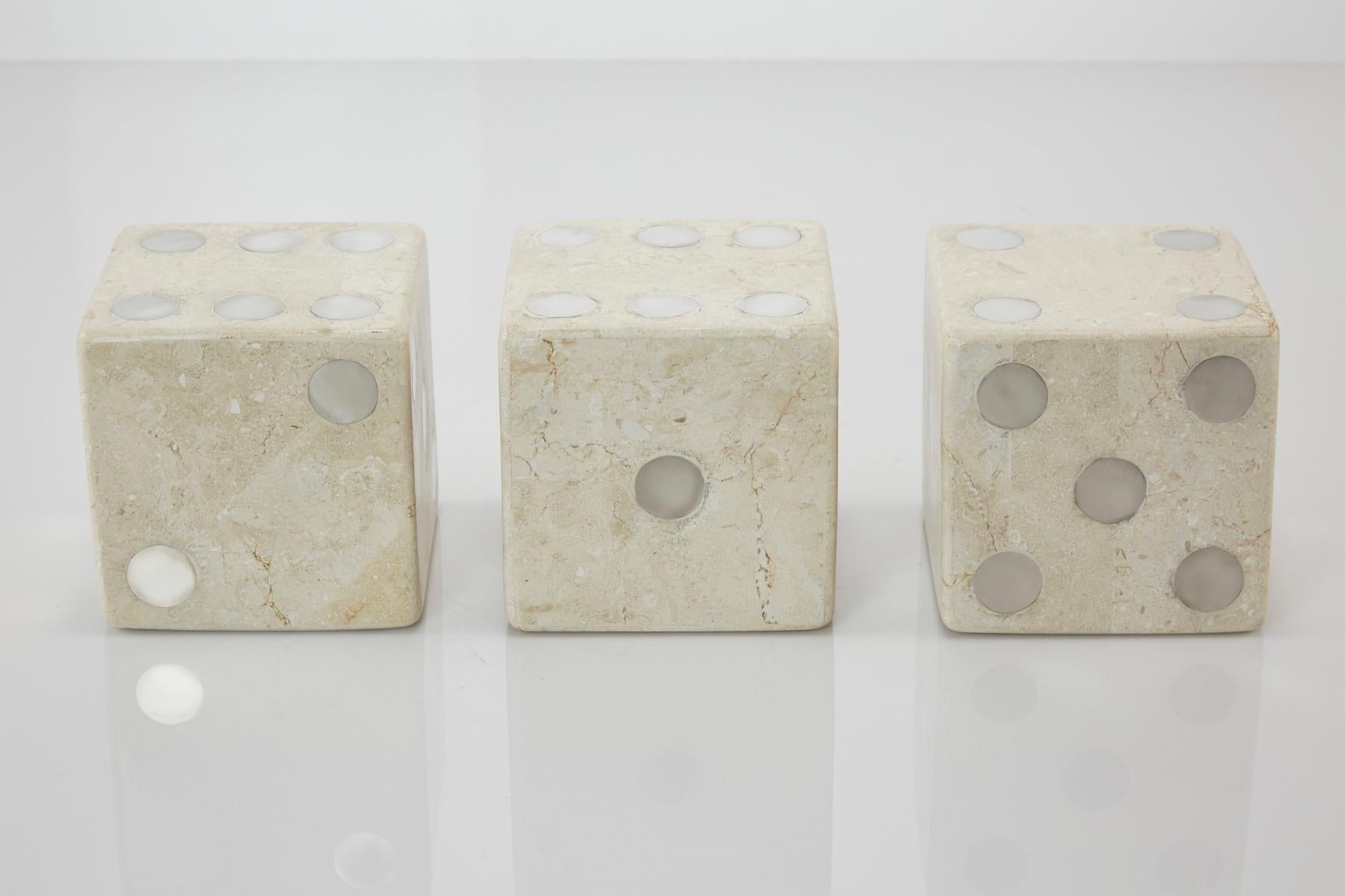 Set of three large decorative dice. Each comprised of white tessellated stone inlay over wooden bodies with stainless steel accents. Oversized at 5