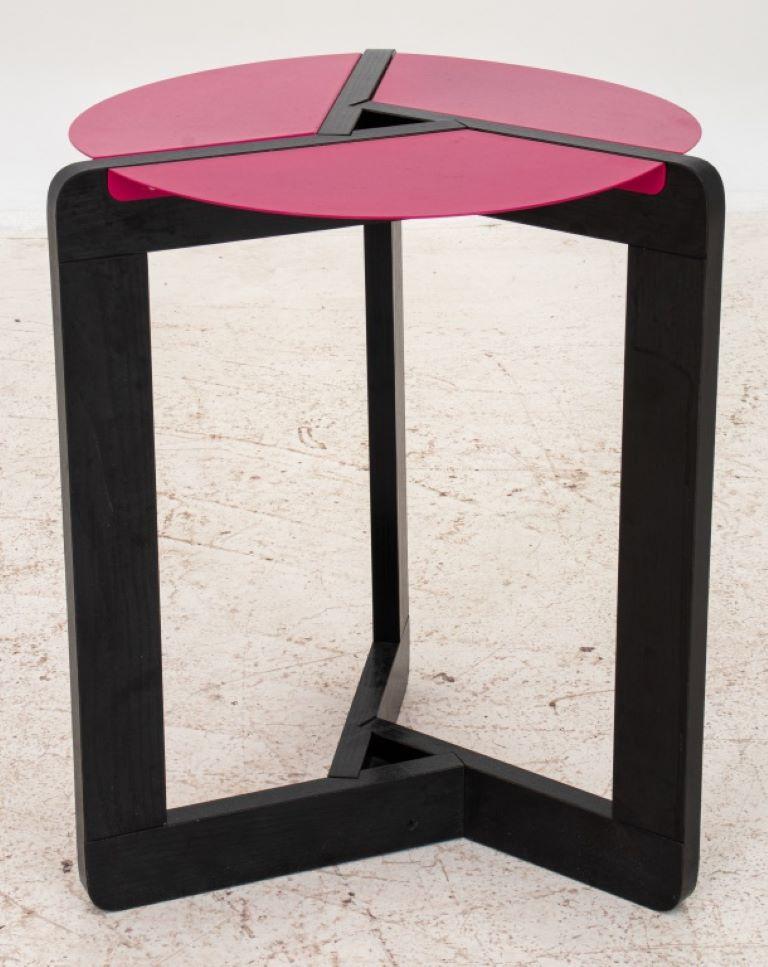 Postmodern pink and black side table, with angular frame supports with shocking pink inserts which create a round table top.

Dealer: S138XX