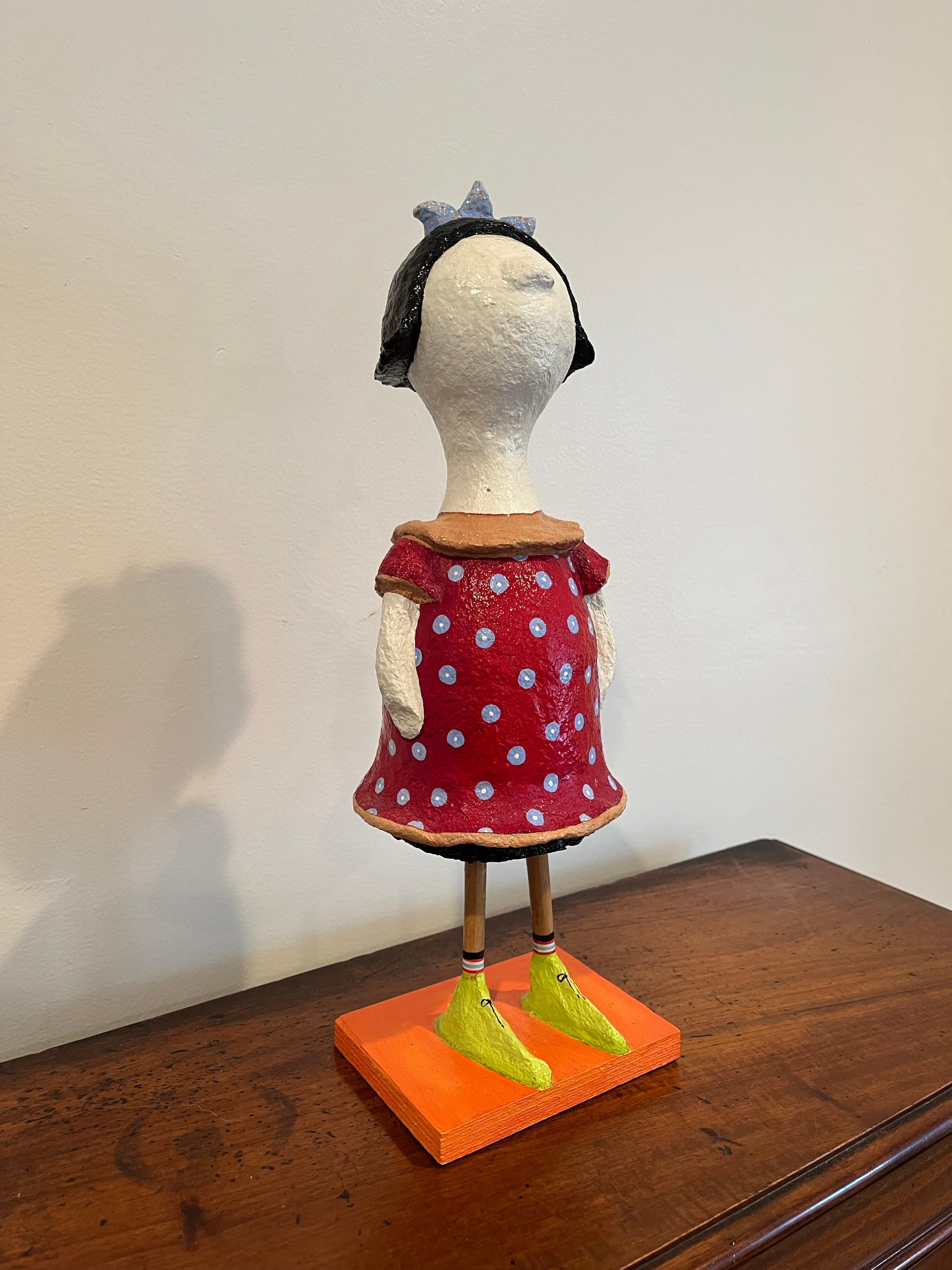 Sweet whimsical postmodern paper mache sculpture of a woman or girl in by Artist Shosh in the manner of Patience Brewster for Mackenzie Childs. Vivid colors round out design for a pop of visual. 

Shosh, a multidisciplinary artist, member of Kibbutz