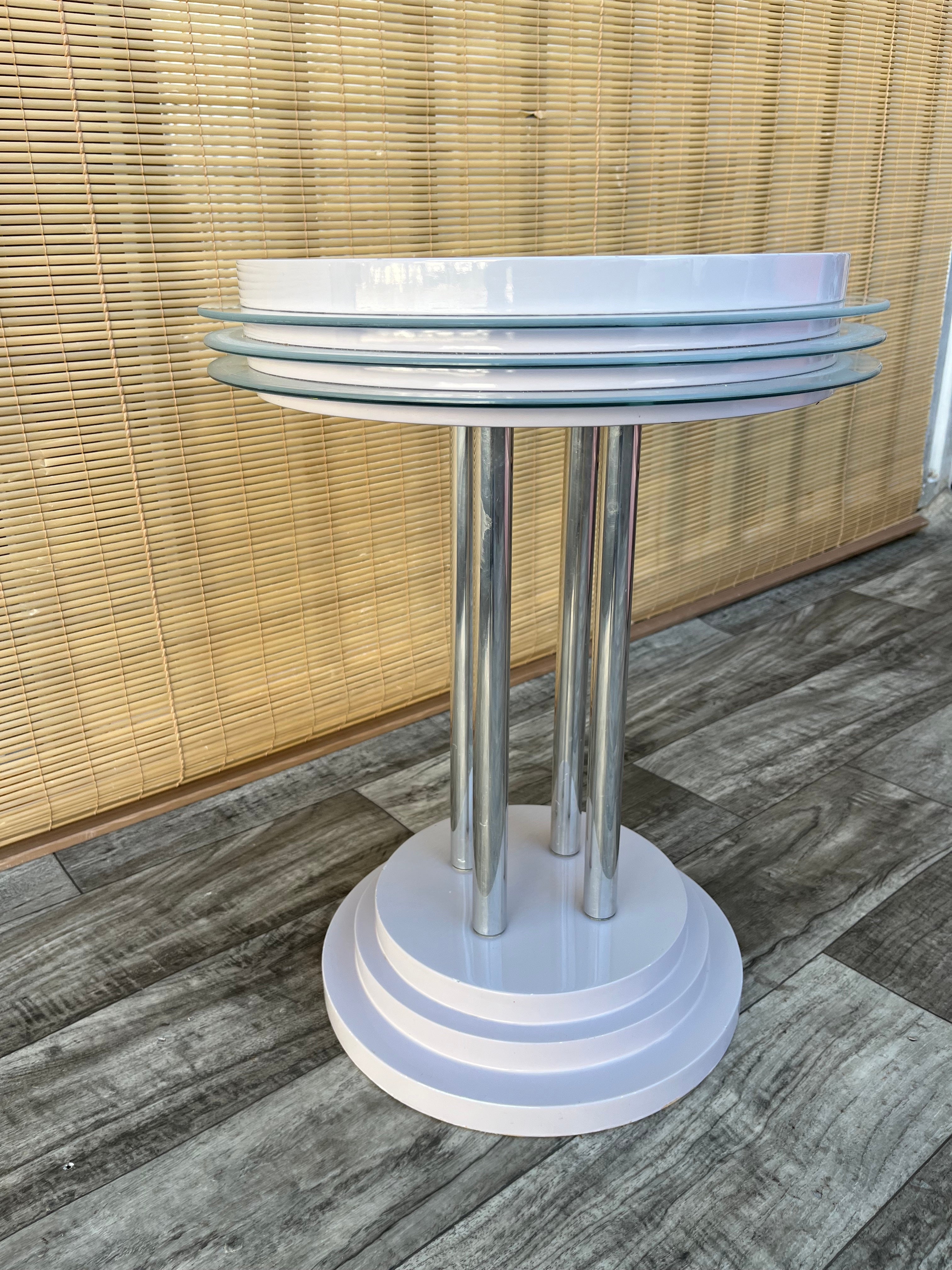 Vintage Postmodern Side Table in the Memphis Group Style. Circa 1980s
Features a quintessential 1980s postmodern design, with chrome pedestals, pastel colors lacquer and glass inserts.
In excellent original conditions, with very minor signs of wear