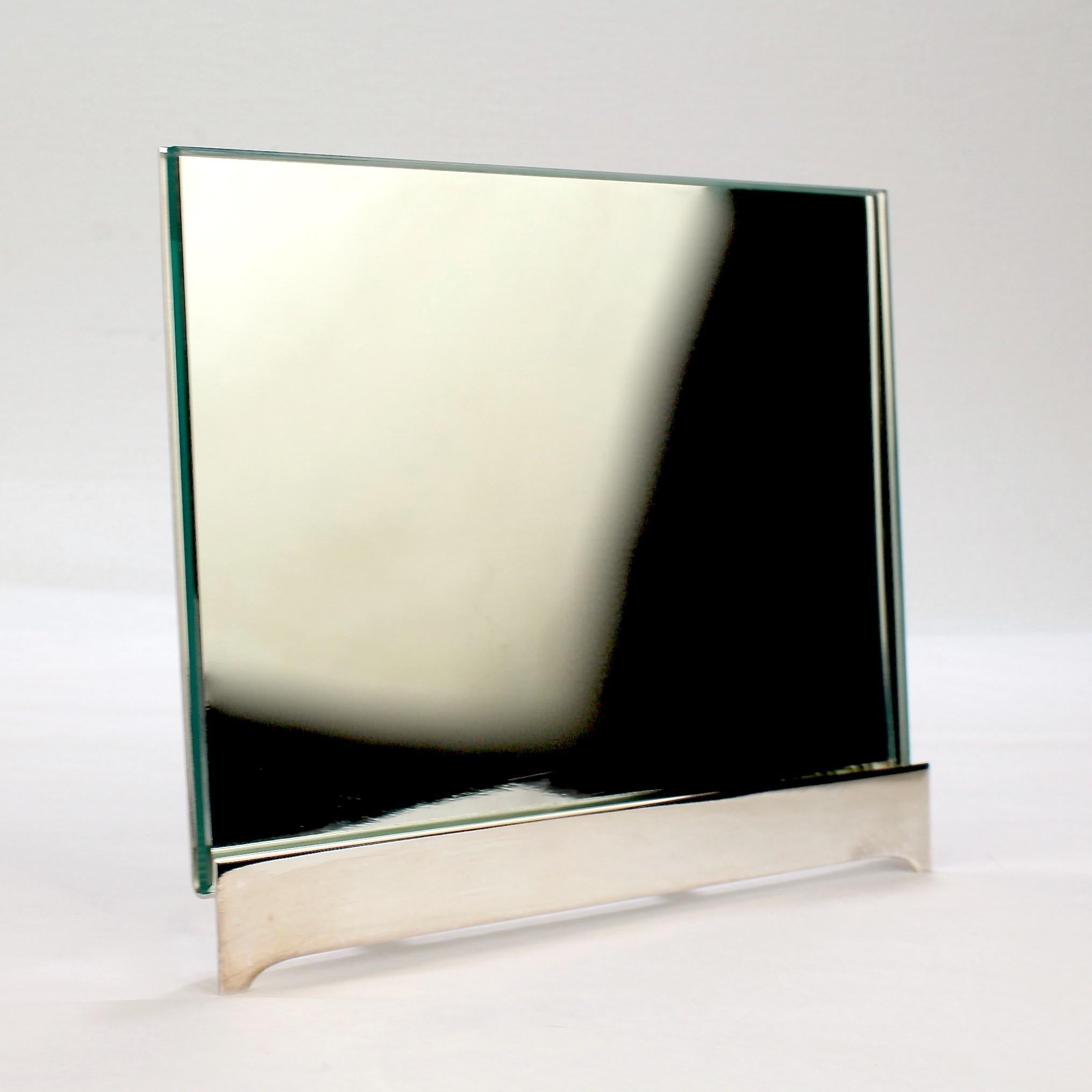 A wonderful postmodern silver-plated easel back frame.

Designed by TsAO & Mckown for Swid Powell.

Model no. 3310.

Comprising a one-piece, welded easel back frame and beveled edge rectangular glass panel.

Together with its original box and