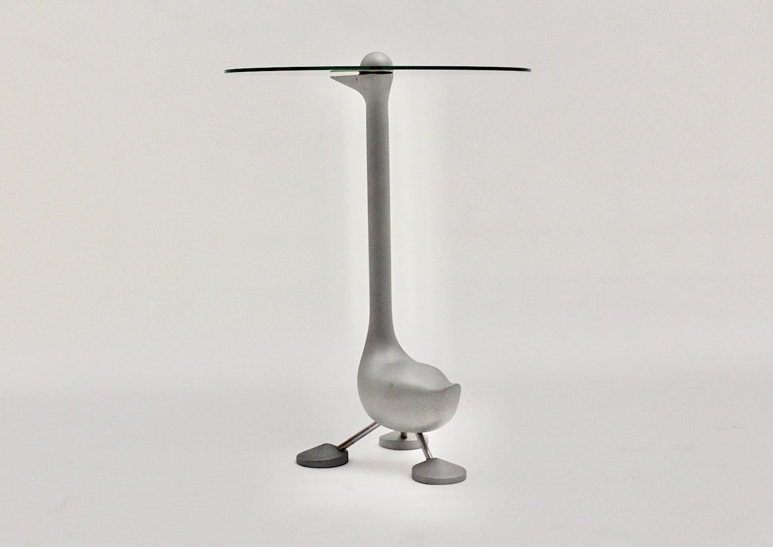 Post-Modern vintage side table sirfo goose table from cast aluminum in silver color with yellow beak by Alessando Mendini for Zanotta edizione 1986, Italy.
A stunning side table in whimsical goose shape in silver color with yellow beak and a clear