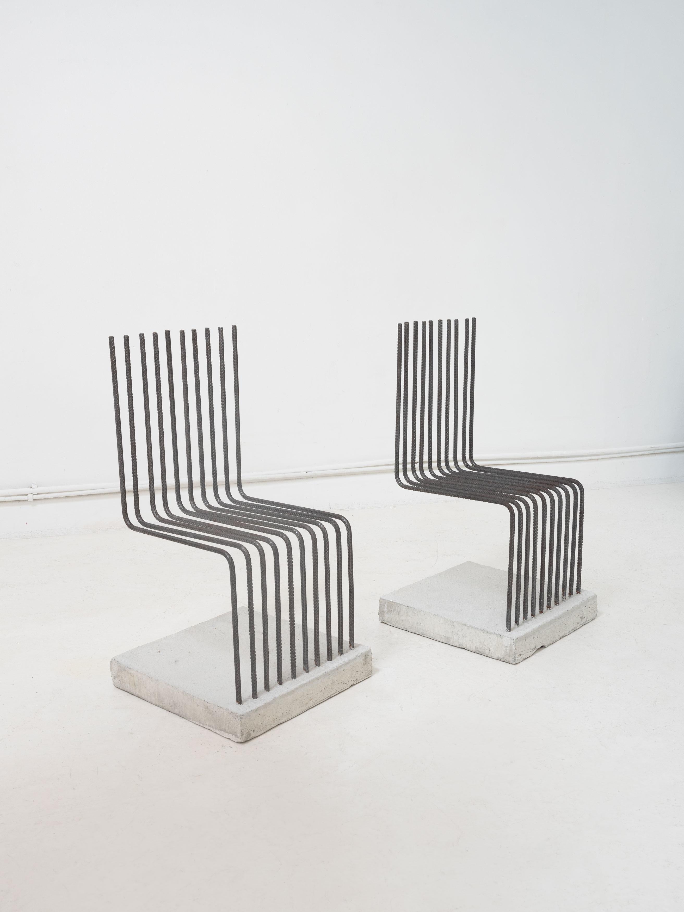 Postmodern 'Solid chairs' designed by Heinz Landes in 1986 as part of the Neues Deutsches Design movement. Composed from bent rebar set in to concrete bases. The chairs are industrial, rebellious and playful, standing apart whist also conforming to