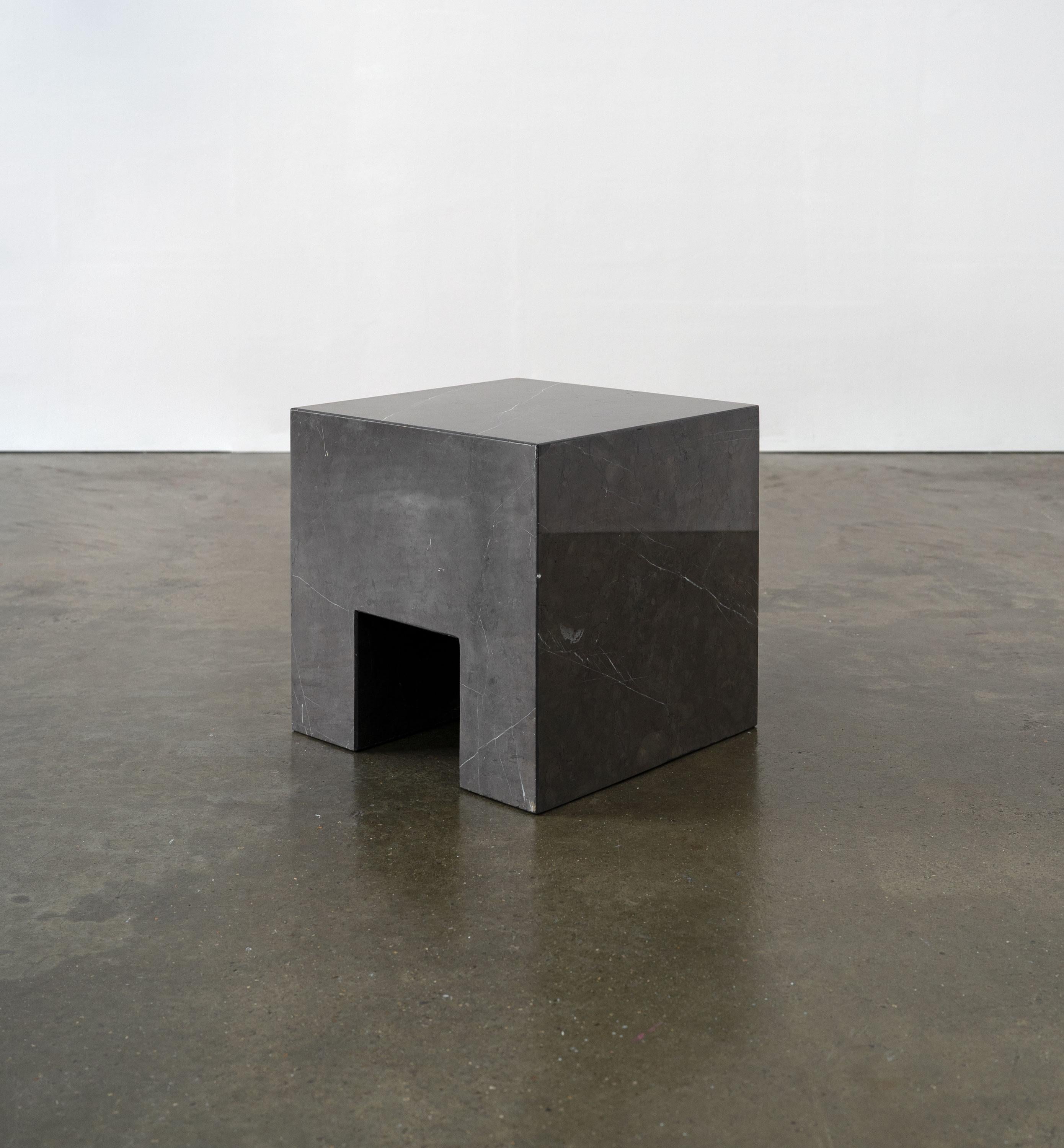 An artist made, minimalist side table / stool, carved from one piece of solid marble. A sculptural piece designed to be placed in various orientations. 

Dimensions (cm, approx)
Height: 35
Width: 35
Depth: 35