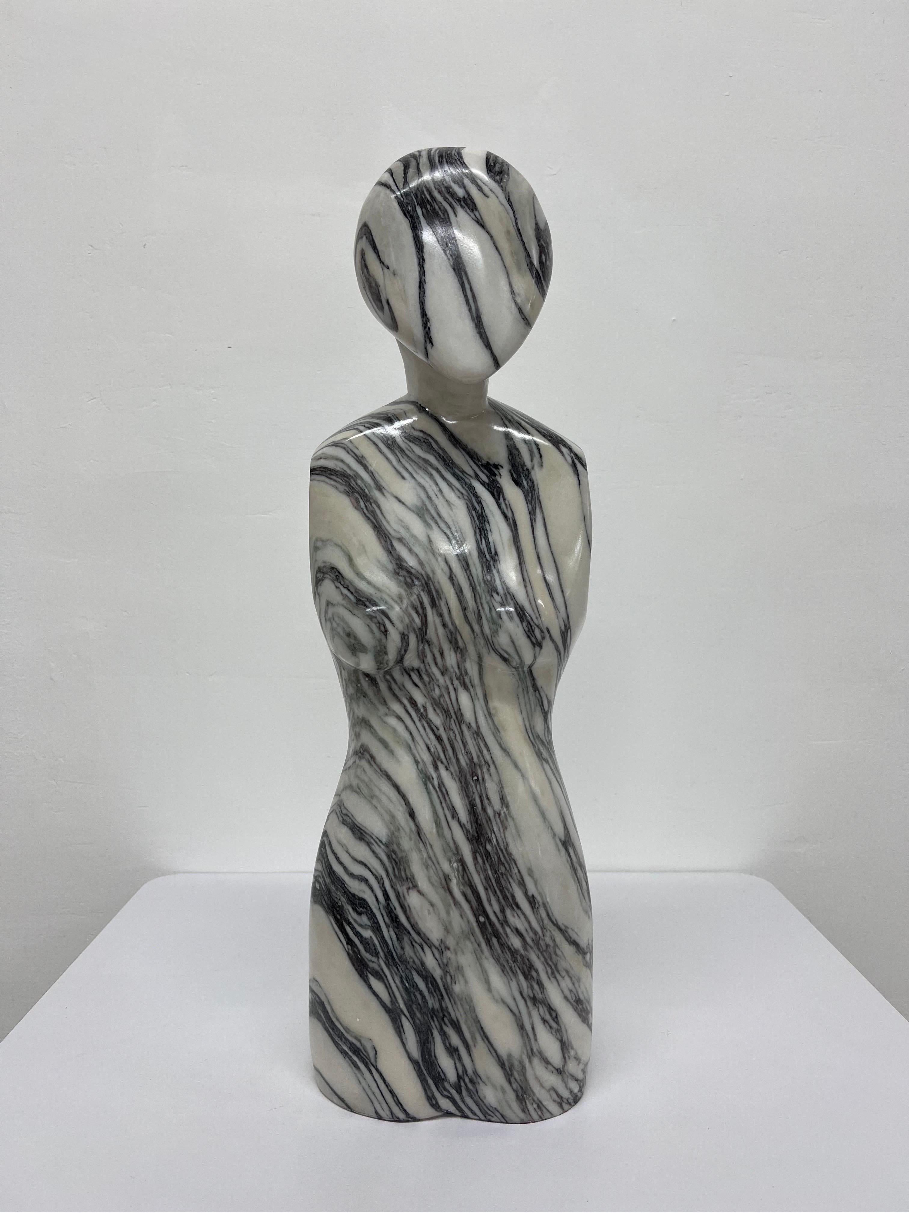 Postmodern female sculpture carved from a solid block of Italian marble, 1980s.

This piece was removed from a built in pedestal and was attached using a bolt. Due to the size, we highly recommend professional installation or fabricating a new