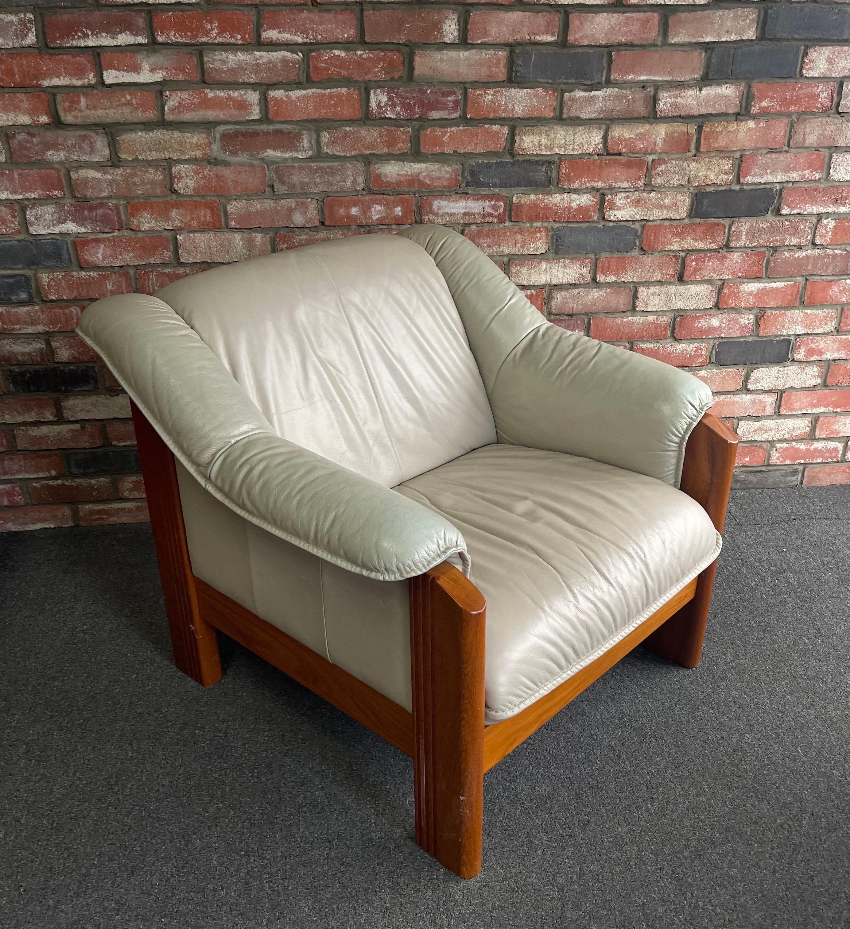 Striking postmodern solid teak and tan leather armchair by Ekorness, circa 1980s. The chair is in very good vintage condition and is very comfortable to sit in. I have a second identical chair available for sale; the tan color is a tiny bit lighter.