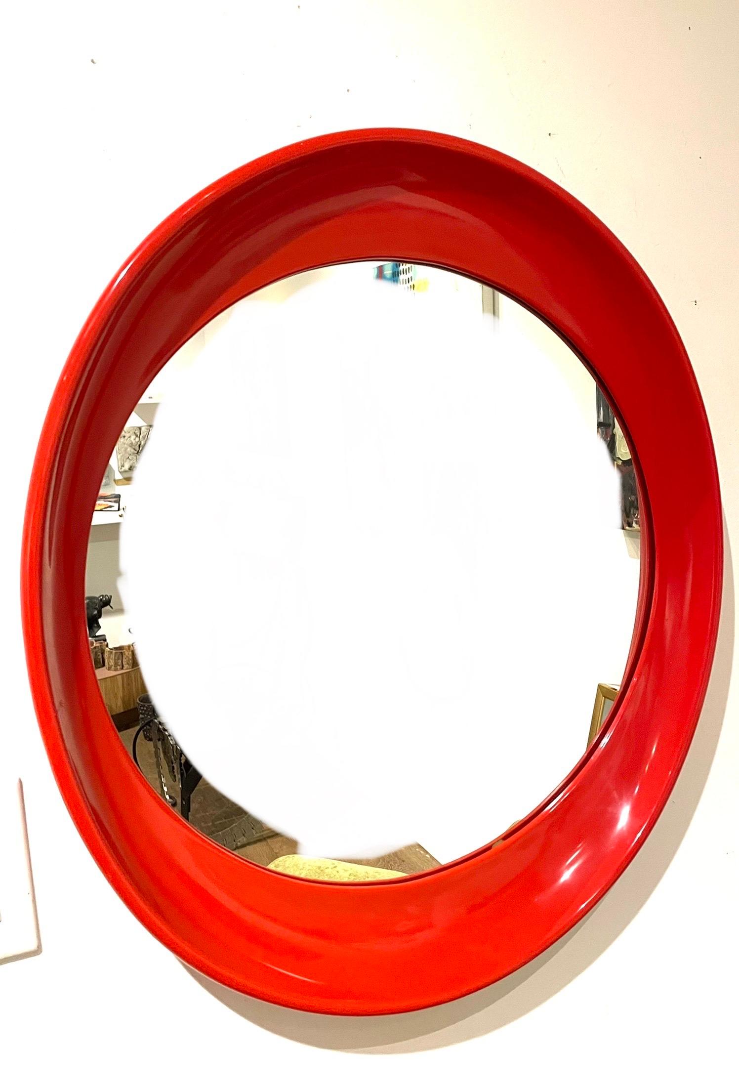 Nice red plastic frame mirror oval shape excellent condition, circa 1980's beautiful and unique.