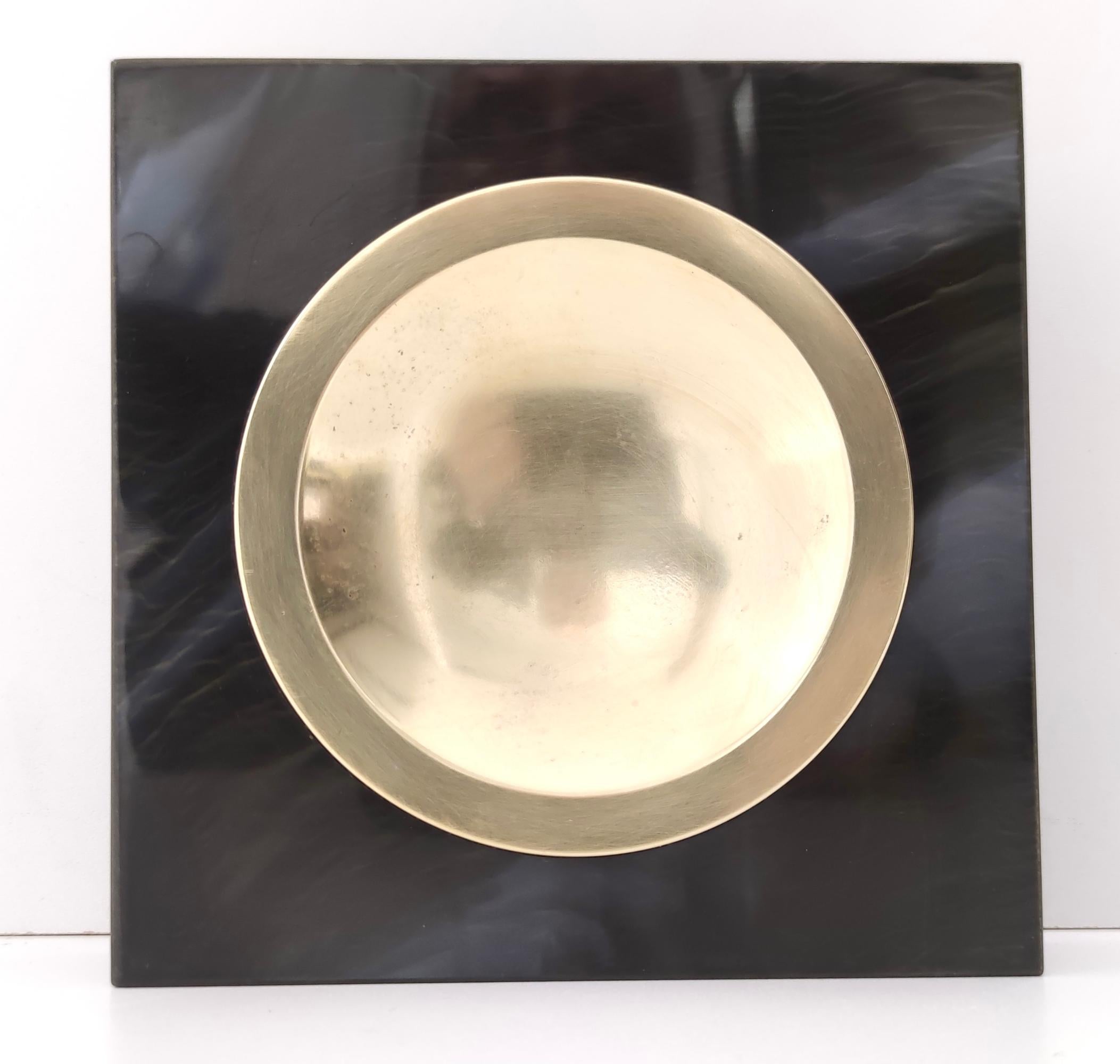 Made in Italy, 1970s.
This ashtray is made in brass and faux black marble.
It is vintage, therefore it might show slight traces of use, but it can be considered as in excellent original condition.

Measures: 
Width: 17cm
Depth: 17 cm 
Height: 4.2