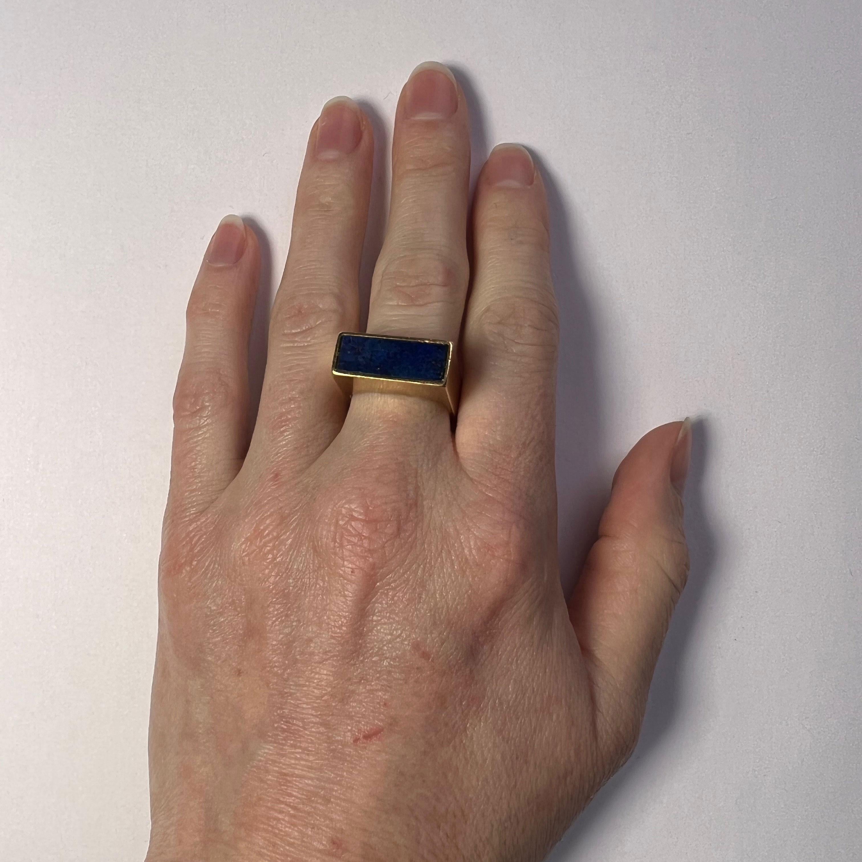 An architectural modernist 18 karat ring set with a rectangular panel of lapis lazuli to the head of the ring.

The outline of this ring is square, meaning that this ring may also function as a sculpture when not being worn.

Stamped 18K for 18