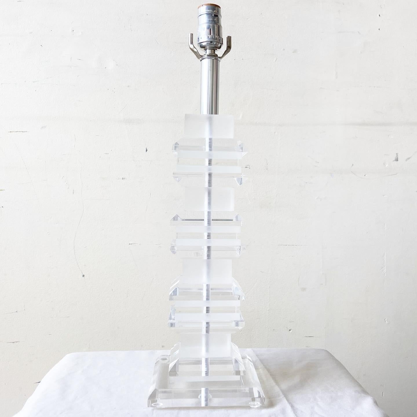 Other worldly Mid-Century Modern lucite table lamp. Body is comprised of a stacked lucite.
  