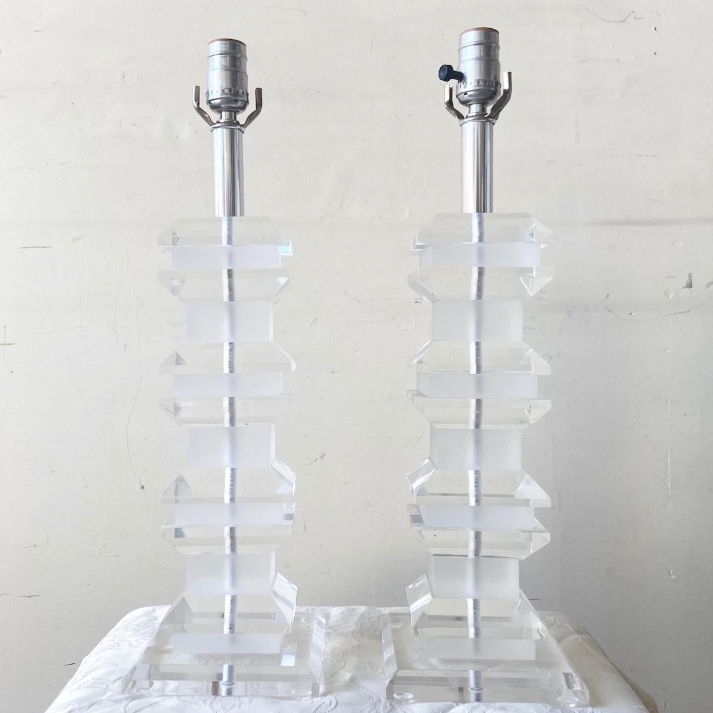 Amazing pair of mid Century Modern lucite table lamps. Each features a stacked lucite pagoda body. 3 way lighting.

Additional information: 
Material: Lucite
Color: Transparent
Style: Postmodern
Time Period: 1980s
Place of origin: USA
Dimension: