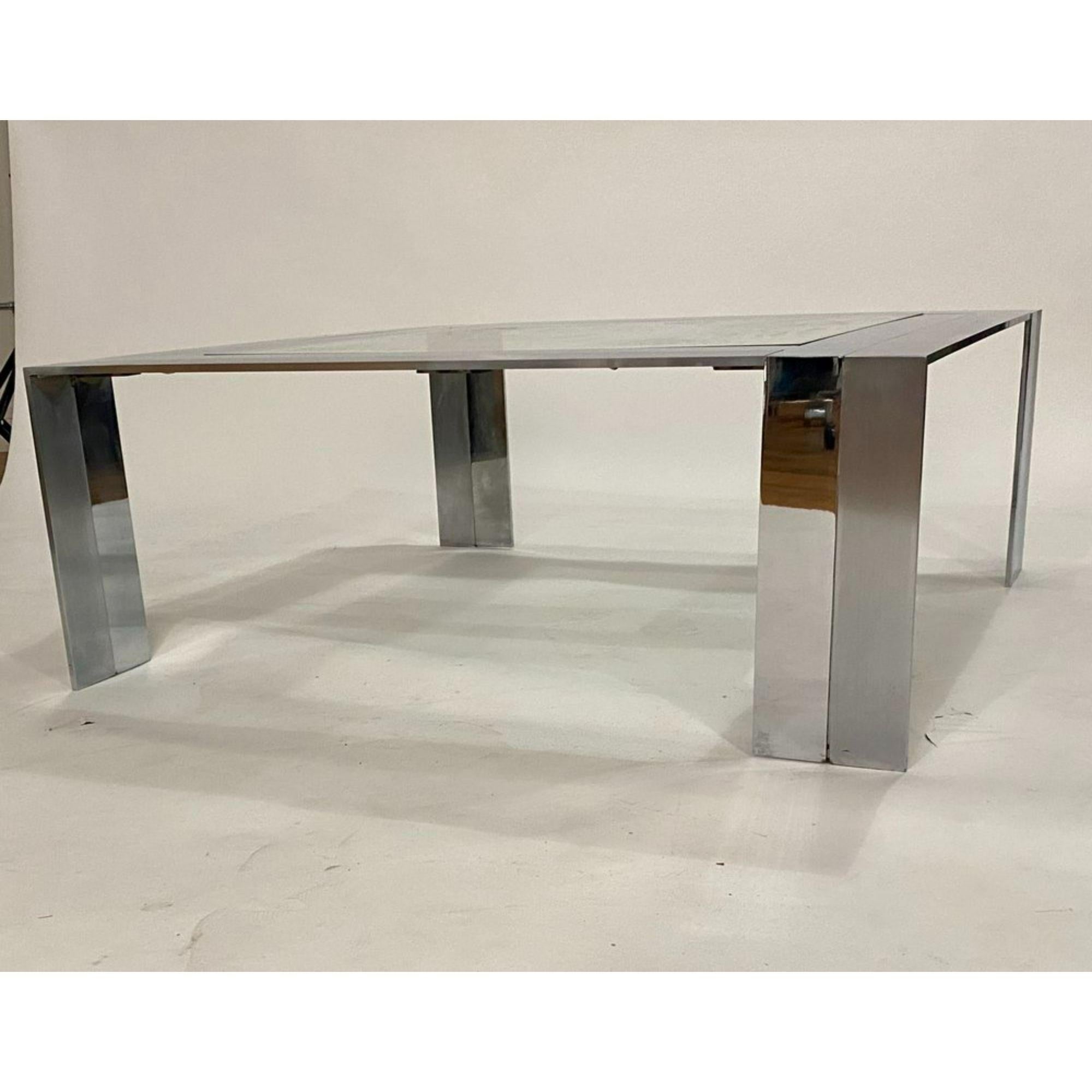 Post-modern steel and glass cocktail table by Elaine Cohen for DIA (Design Institute of America crafted from solid sleek bars of polished and brushed nickel and topped with a square glass. The table is very solid and heavy and in very good