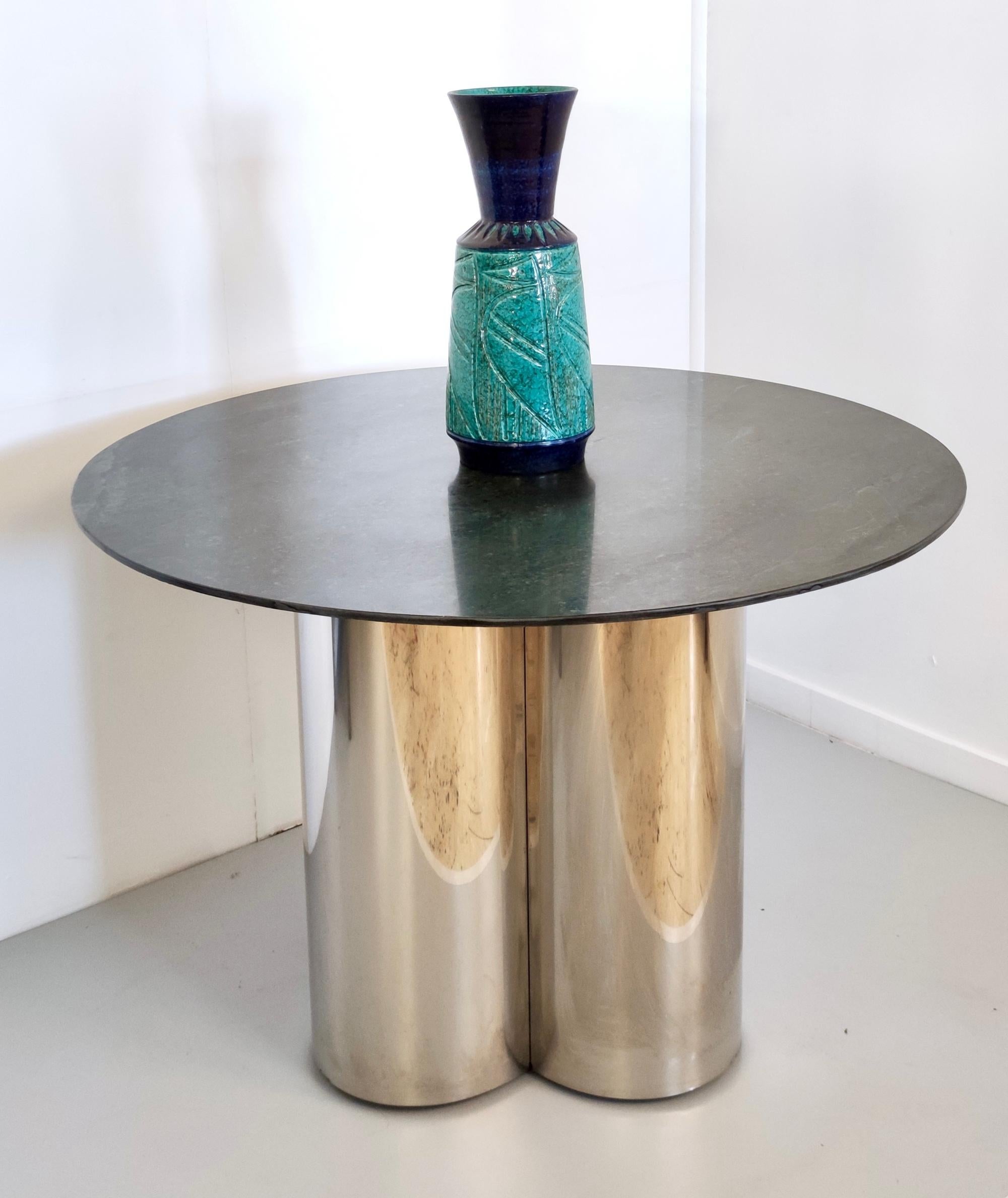 Made in Italy, 1970s. 
This table features a steel pedestal and a green marble top.  
It is a vintage item therefore it might show slight traces of use, but it is in excellent original condition and ready to become a piece in a home.

Measures: