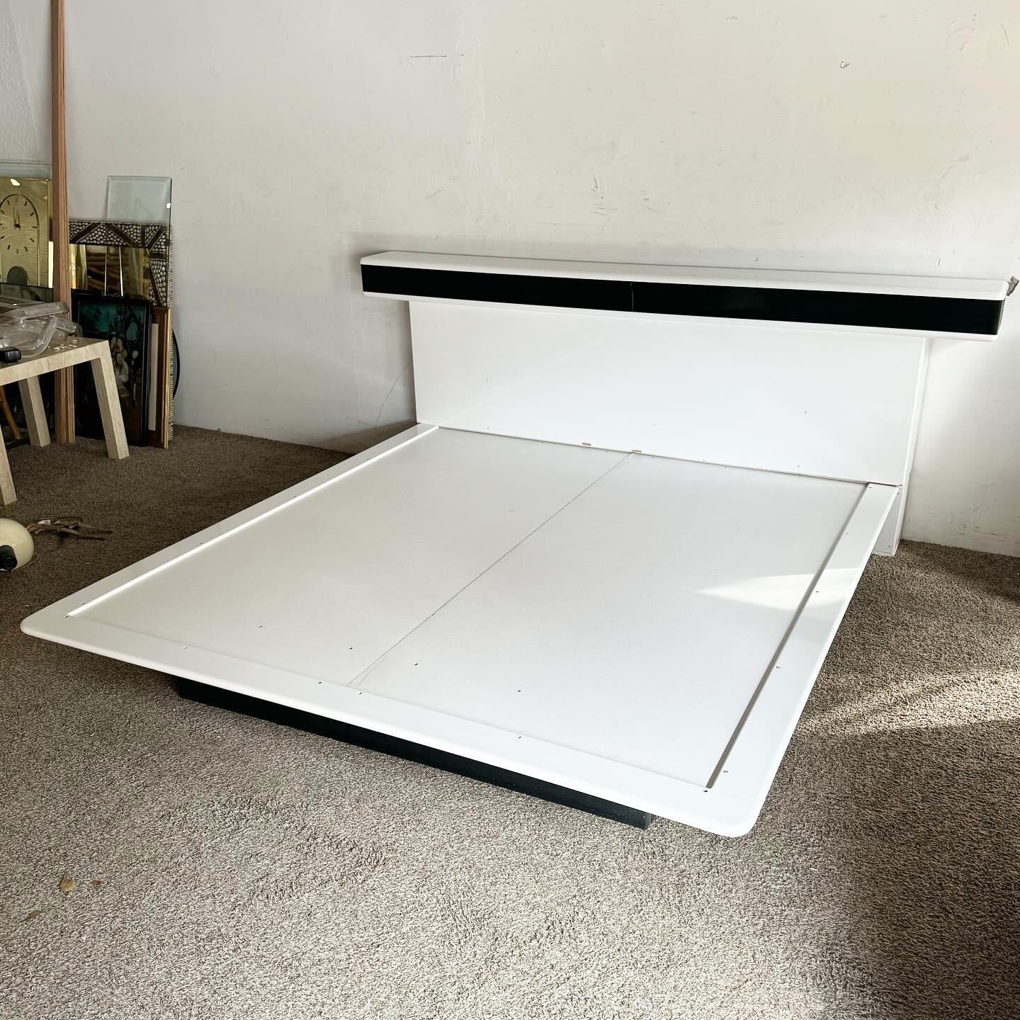 Dive into the future of bedroom style with the Postmodern Storm Trooper White Lacquered and Black Long Platform Bed. This bed features a white lacquered finish with black accents, inspired by Storm Trooper aesthetics. The long platform design offers