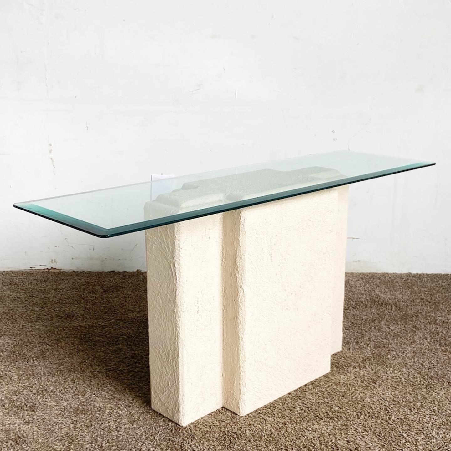 Discover our Postmodern Stucco Plaster Glass Top Console Table, blending a sculpted stucco base with a sleek glass top for an artistic and functional piece.

Unique sculpted cruciform base crafted from stucco-textured plaster.
Rectangular glass top