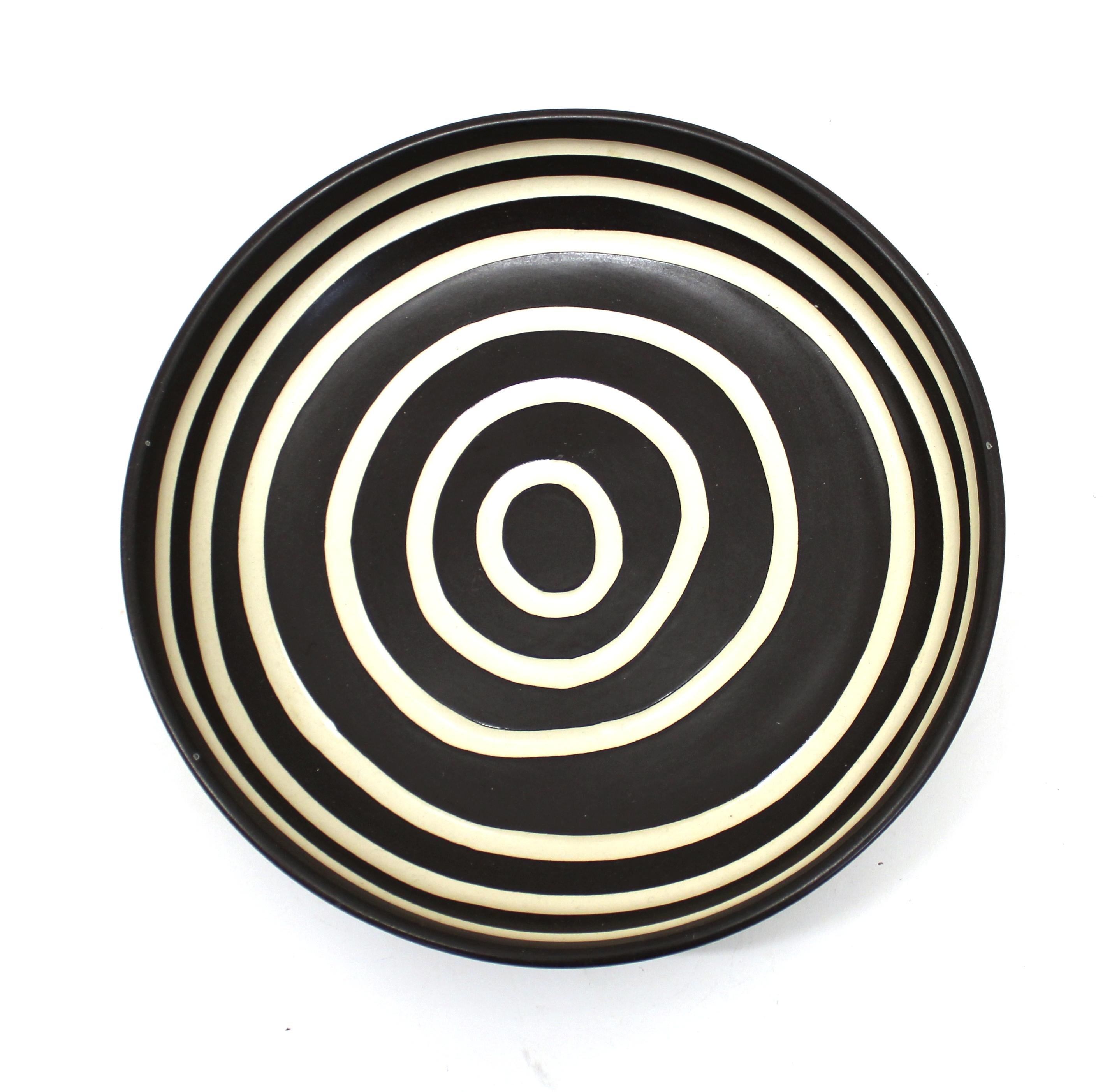 Postmodern studio pottery charger plate with concentric circles, marked on the bottom.