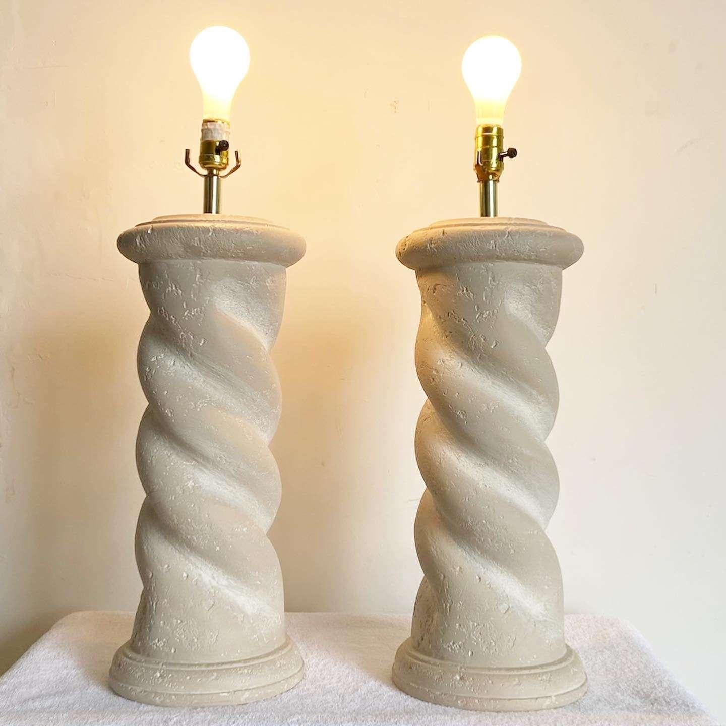 Amazing pair vintage postmodern plaster table lamp by Bloomingdale’s. Each feature a beige natural finish with a sculpted swim pillar body. 
