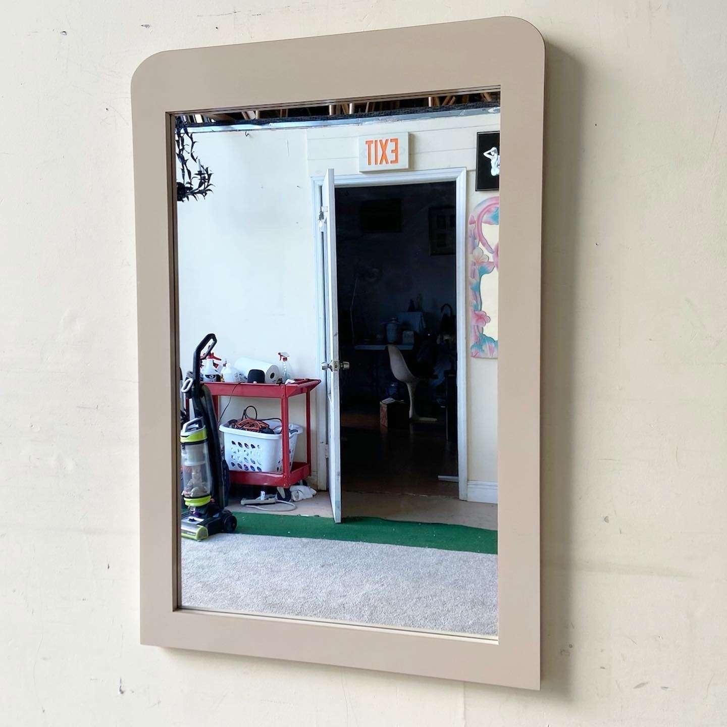 Amazing vintage postmodern hanging mirror. Features a tan lacquer laminate with a waterfall top.