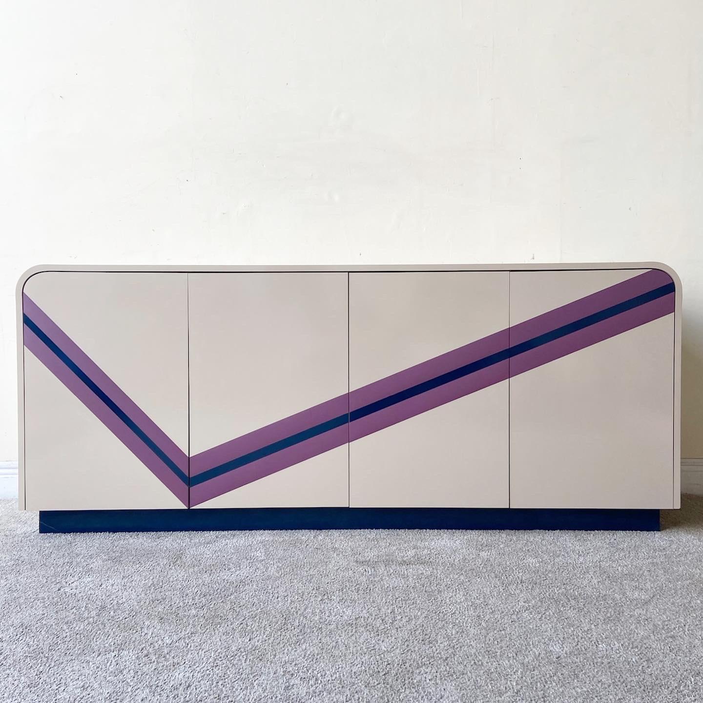 Incredible 1980s Postmodern Tan Lacquer Laminate waterfall credenza. Features 4 cabinet door which open to reveal shelved storage space and a section of 3 drawers. Displayed across the front of the piece is a purple and navy blue check.