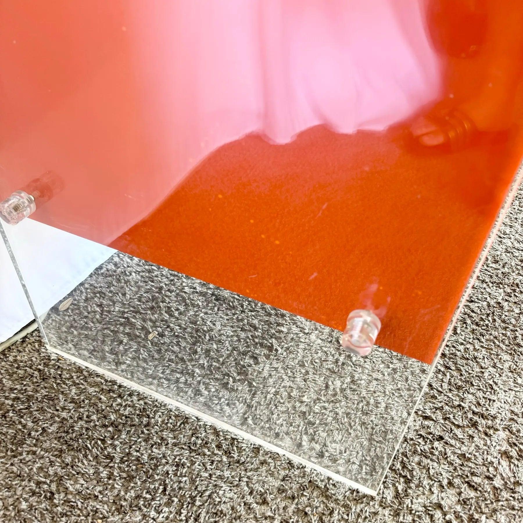 Postmodern Tangerine Laminate Writing Desk with Lucite accents, finished back, and spacious drawers—perfect for a stylish home office.
 
 One of the lucite knobs on the back bottom corner has cracking which does not affect the integrity of its